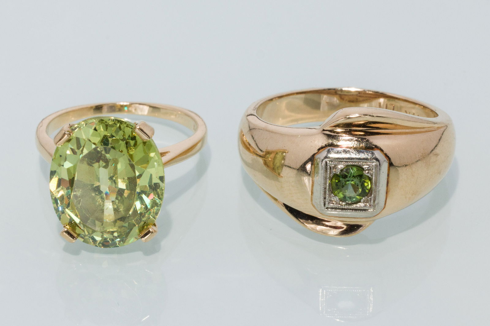 Two Ladies Peridot Rings: Property from a Private Collection, Jacksonville, FL Description: Two Ladies Peridot Rings, both in 14K yellow gold, one featuring an oval faceted peridot, marked '14K, A&E', size 5.75 (approx. 14