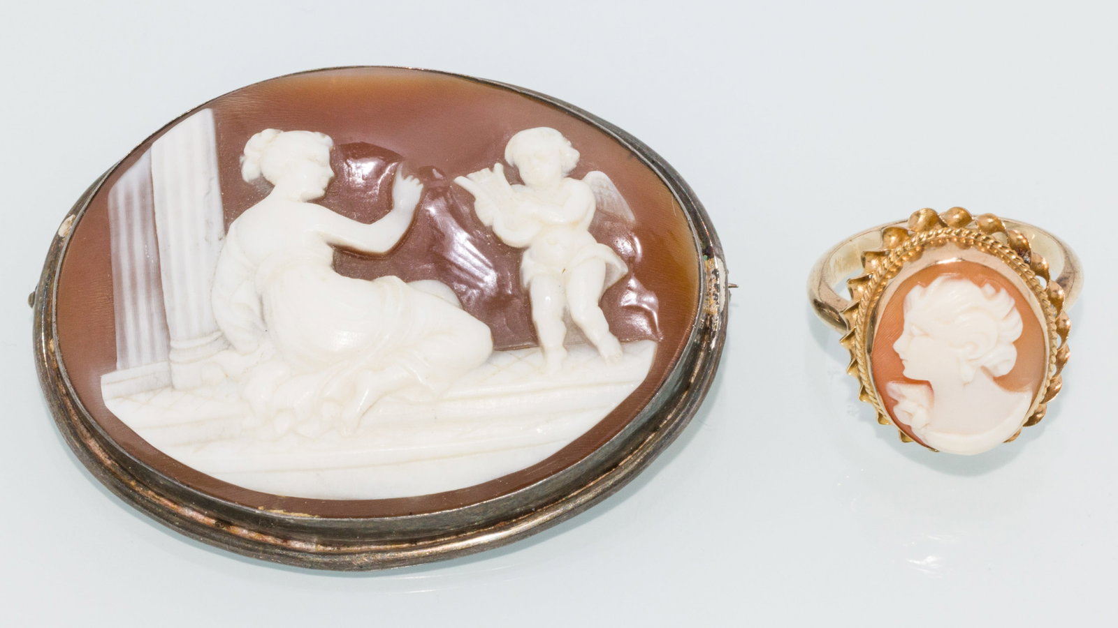 Cameo Brooch and a 14K Cameo Ring: Description: Cameo Brooch and a 14K Cameo Ring, an oval cameo pin with silver surround (marked 800) and a 14K yellow gold ring with oval cameo, size 6.25, 4.26 grams overall (marked 14K on band).
