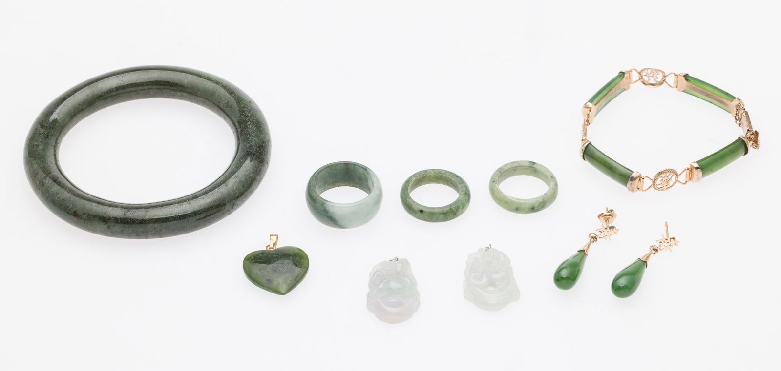 Group of Jade Jewelry, 7 pcs.: Description: Group of Jade Jewelry, 7 pcs. , comprising a 3 1/4 in. jade bangle bracelet; a size 6 jade ring; a size 6.5 jade ring; a size 8.5 jade ring, pair of jade tear drop post earrings with