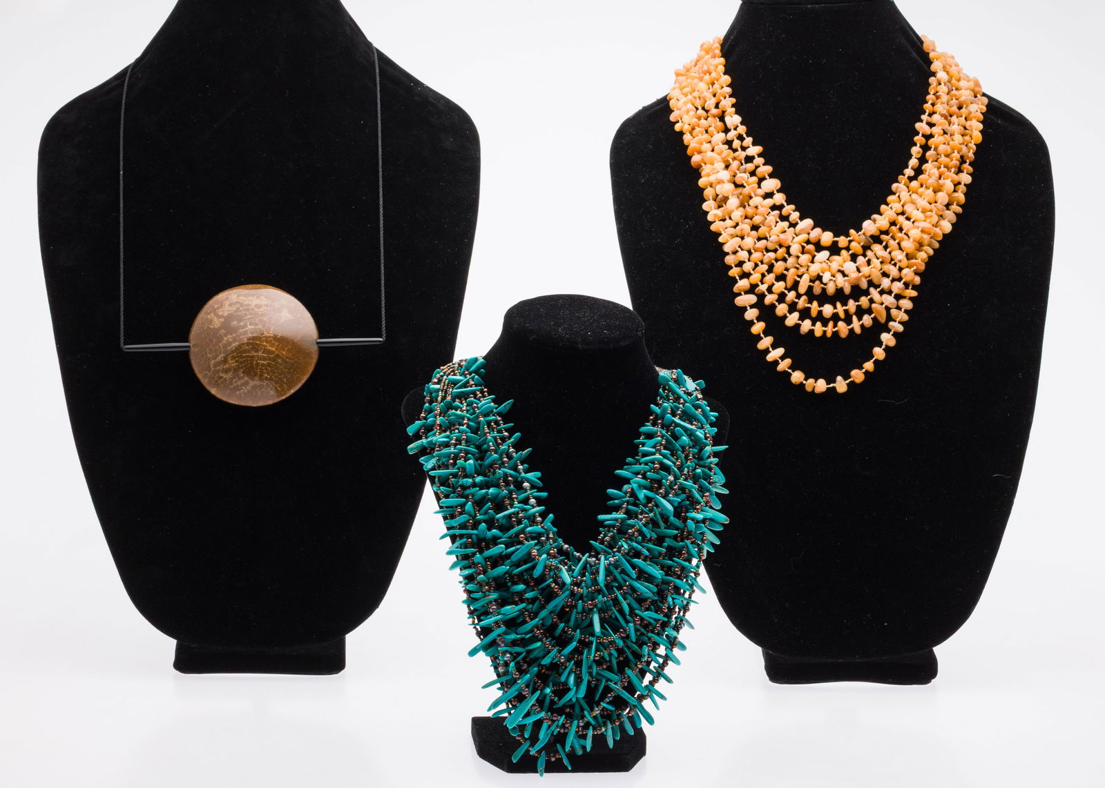 Two Beaded Necklaces and an Acrylic Necklace: Description: Two Beaded Necklaces and an Acrylic Necklace, including a 18 1/2 in. multi strand beaded turquoise necklace with silver tone clasp; 21 1/2 in. multi strand amber necklace, and 12 in.