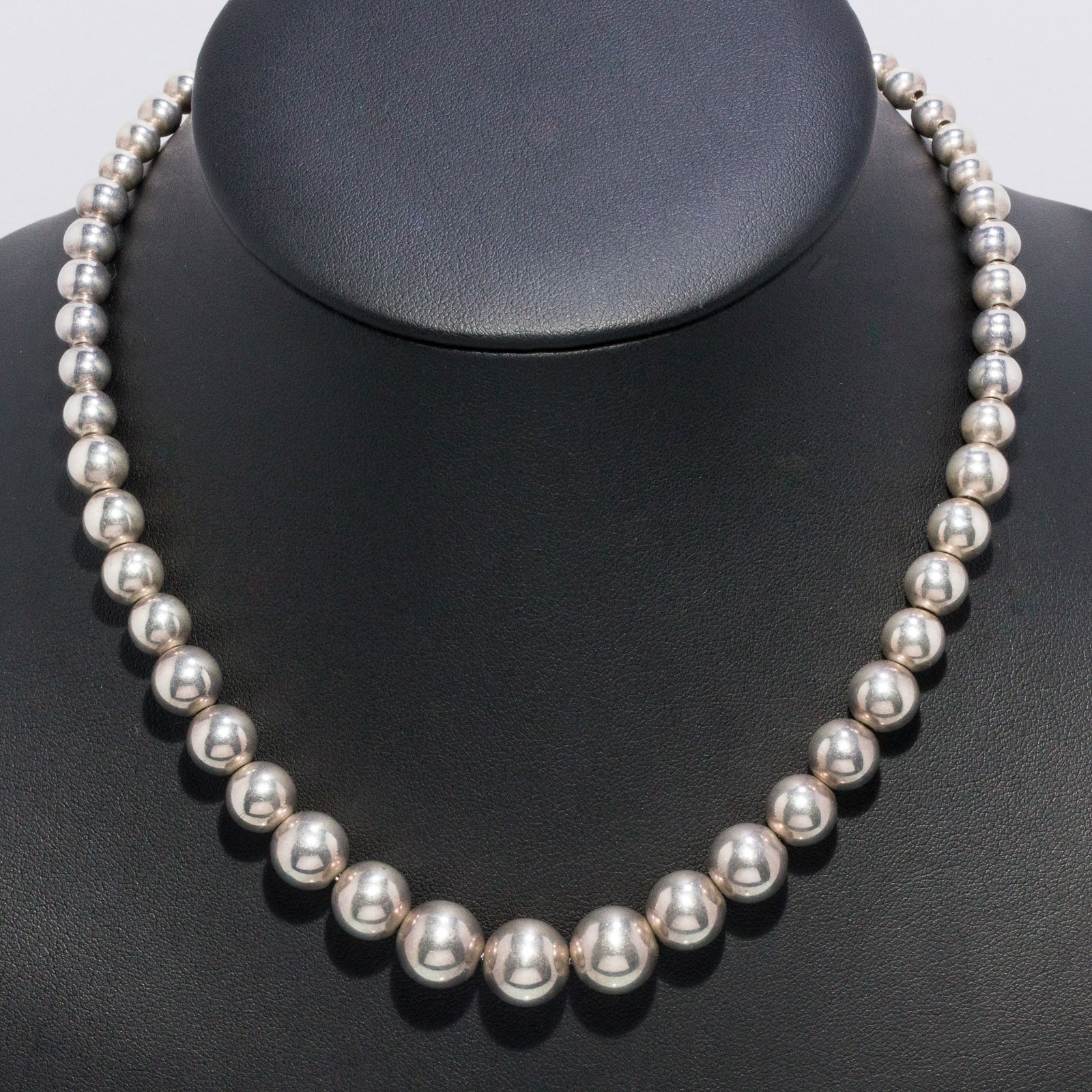 Tiffany Sterling Silver Necklace: Description: Tiffany Sterling Silver Necklace, graduated sterling silver beaded necklace, the beads ranging from 5.9 mm - 11.04 mm, with lobster claw clasp, marked 'Tiffany & Co, 925' on tab by c