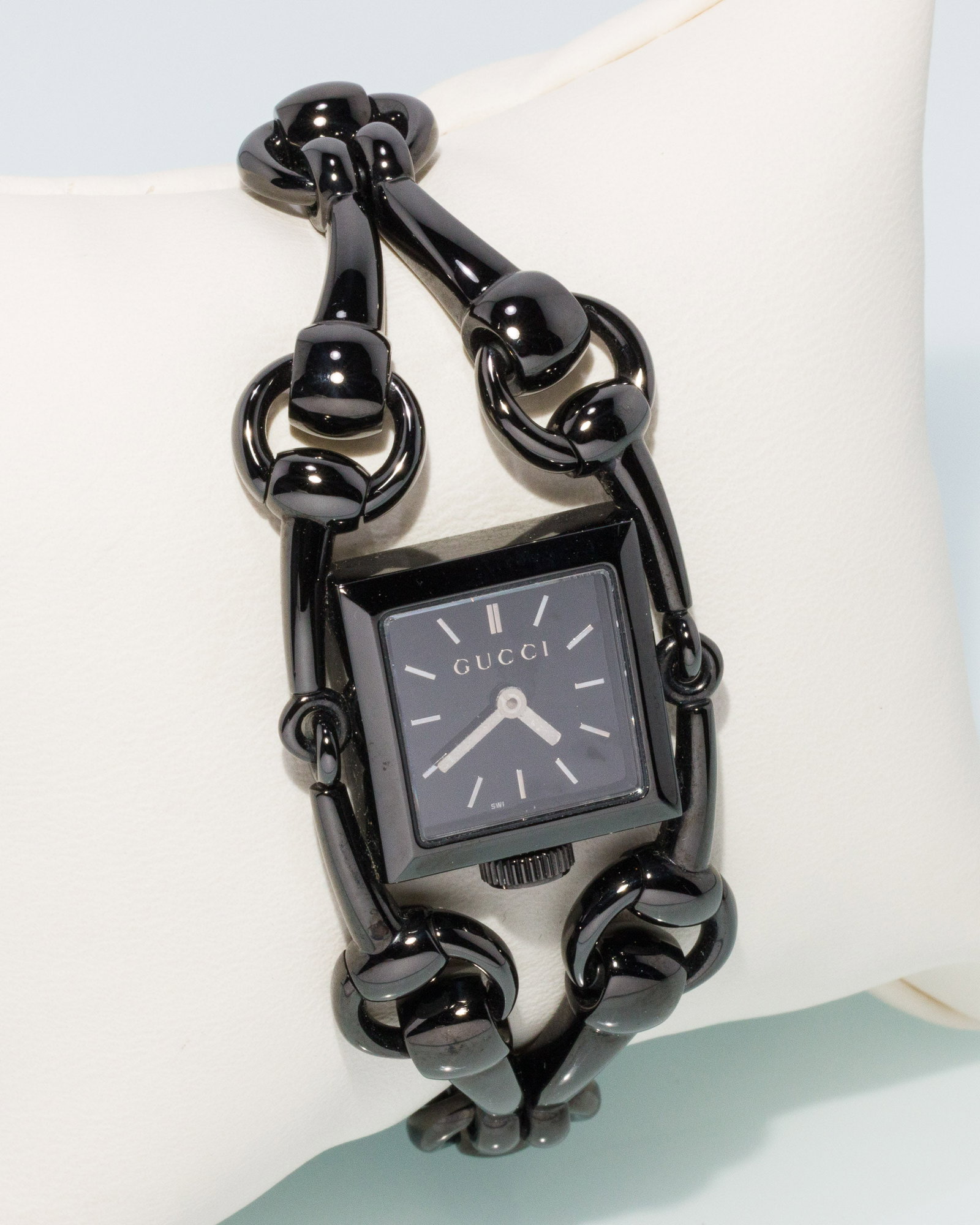 Gucci Horse Bit Watch: Description: Gucci Horse Bit Watch, black stainless steel watch with square face and black dial, the horse bit style bracelet with clasp marked 'Gucci' on front, the back of case marked '116.5, S