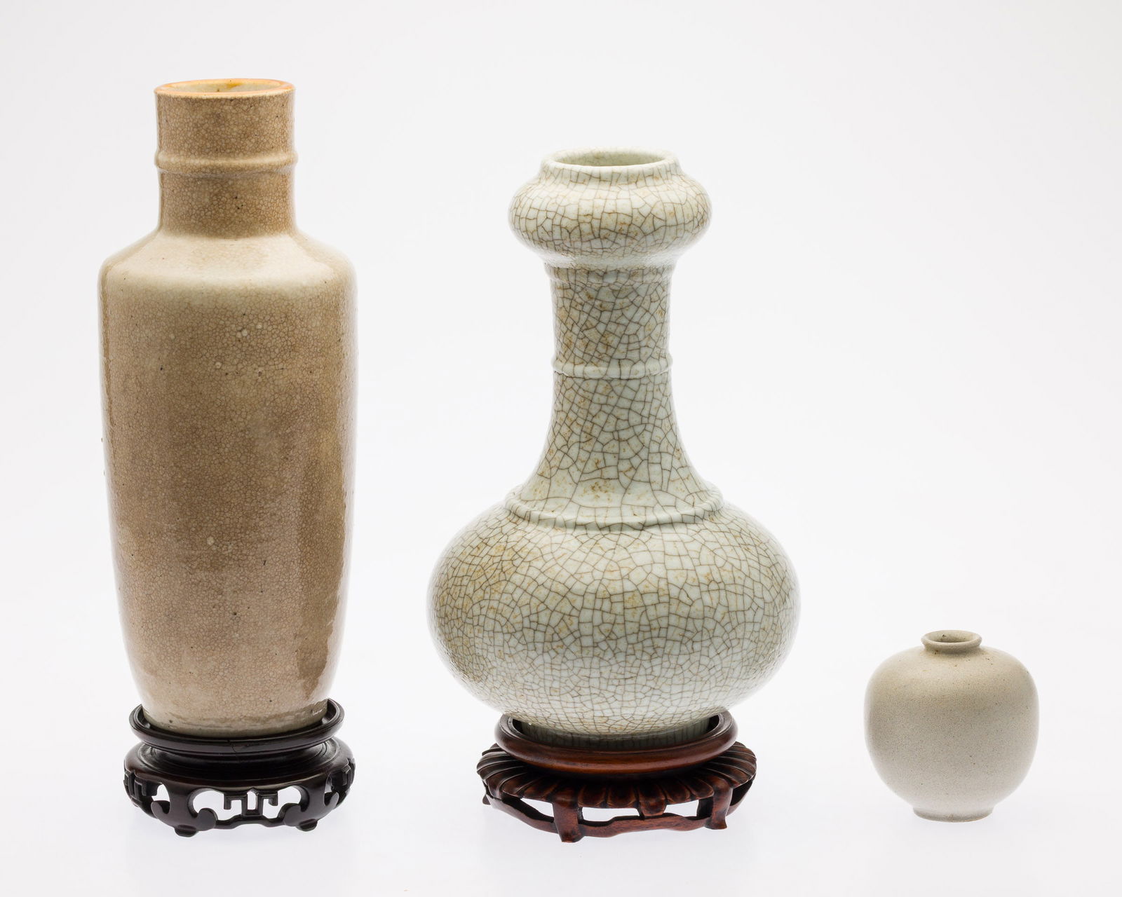 Two Chinese White Crackle Vase and a Small Vase: Property from the Estate of Arthur B. Kouwenhoven Jr., Savannah, GA Description: Two Chinese White Crackle Vase and a Small Vase, comprising a 11 in. x 4 in. white crackle glaze vase with wood sta