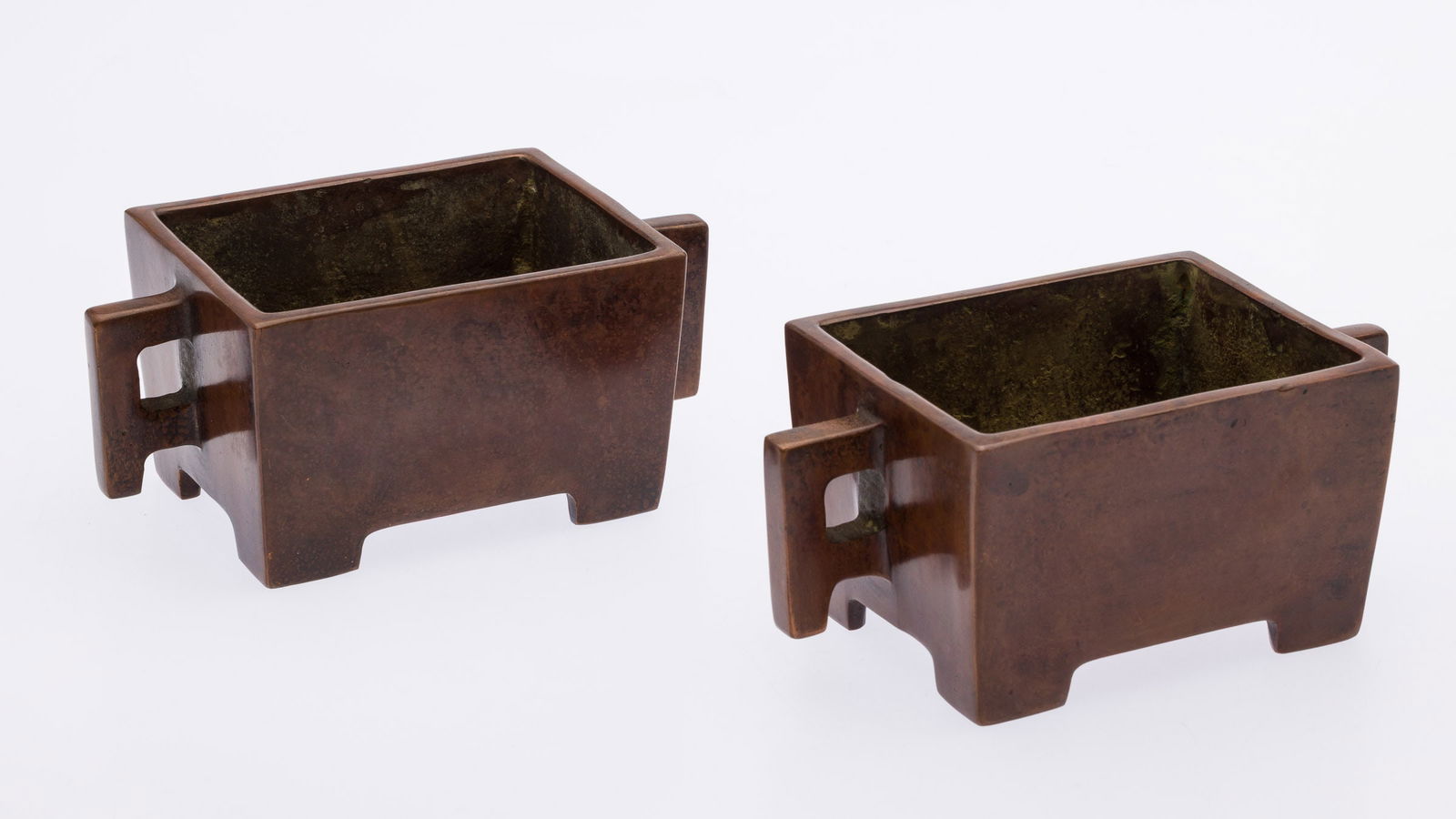 Pair of Small Chinese Rectangular Bronze Urns: Property from the Estate of Arthur B. Kouwenhoven Jr., Savannah, GA Description: Pair of Small Chinese Rectangular Bronze Urns, pair of rectangular bronze urns, both marked on undersides.