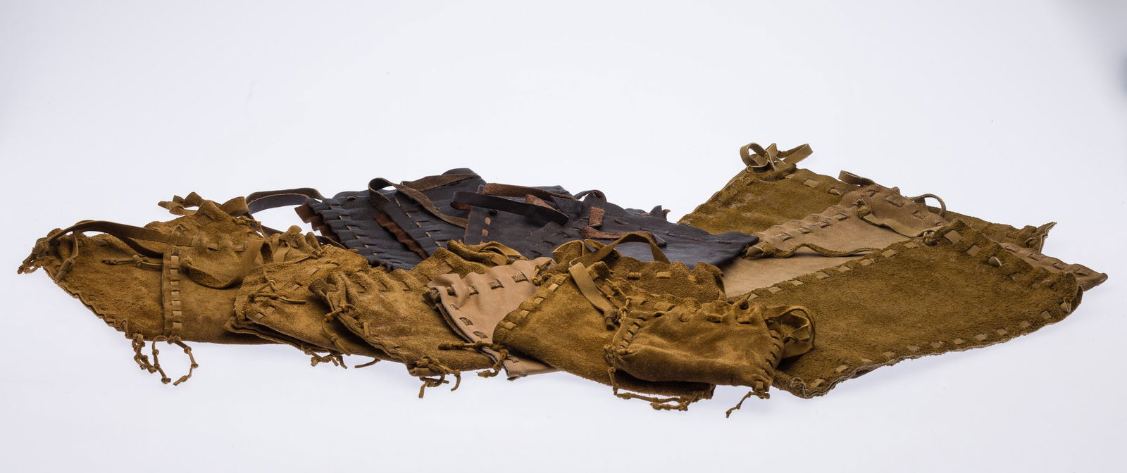 16 Leather Drawstring Bags by Arthur B. Kouwenhoven : Property from the Estate of Arthur B. Kouwenhoven Jr., Savannah, GA Description: 16 Leather Drawstring Bags made by Arthur B. Kouwenhoven (NY/GA, 1936-2025), of various sizes and colors.