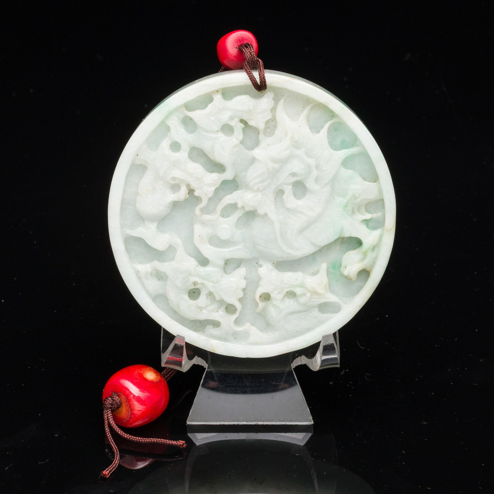 Chinese Carved Jadeite Amulet with Dragon: Property from the Estate of Arthur B. Kouwenhoven Jr., Savannah, GA Description: Chinese Carved Jadeite Amulet with Dragon, circular amulet, both sides carved with dragon motif, on a short cord wi