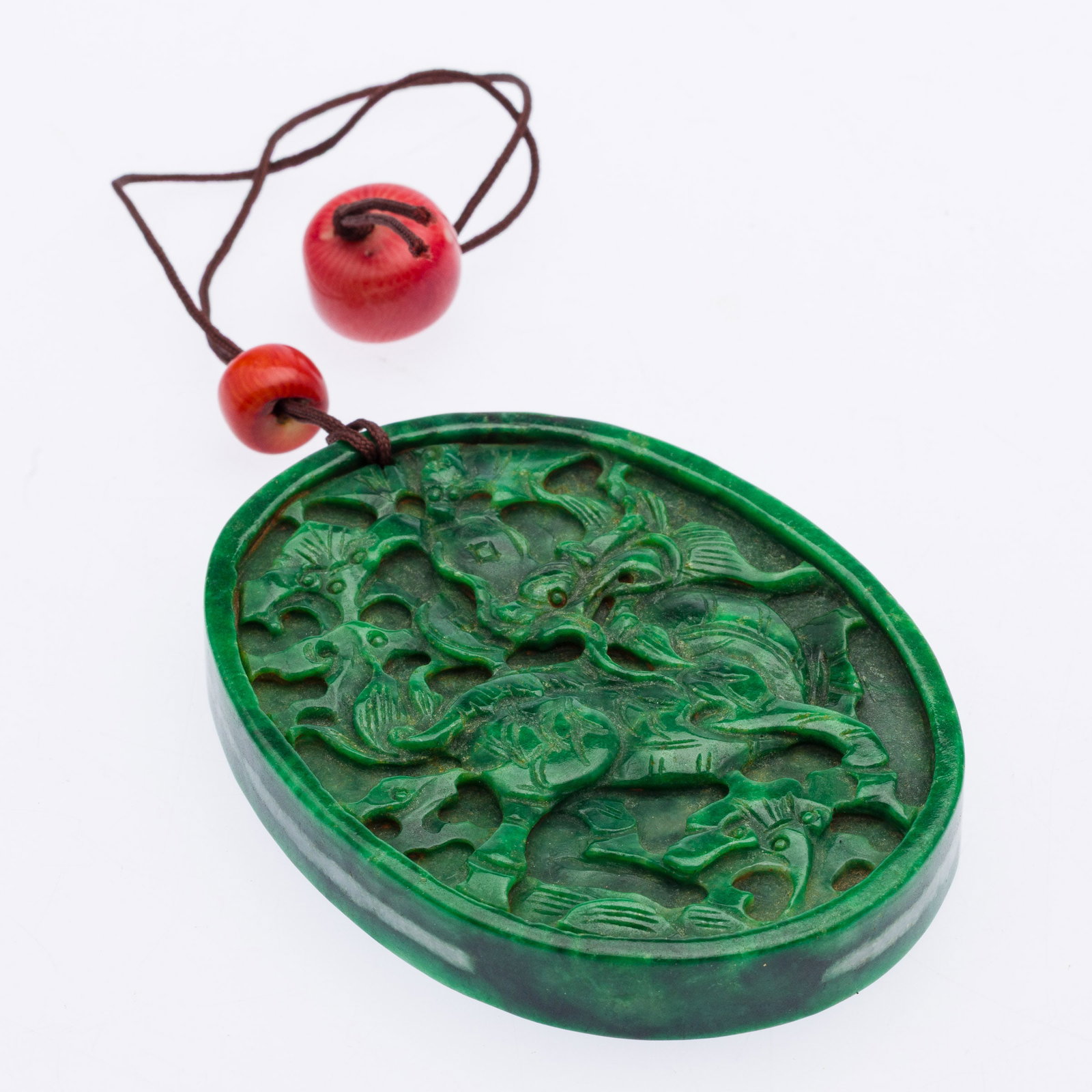 Chinese Carved Green Jade Oval Amulet: Property from the Estate of Arthur B. Kouwenhoven Jr., Savannah, GADescription: Chinese Carved Green Jade Oval Amulet, one side carved with a dragon, the other with a bird.Measurements: Width: 3 1/4