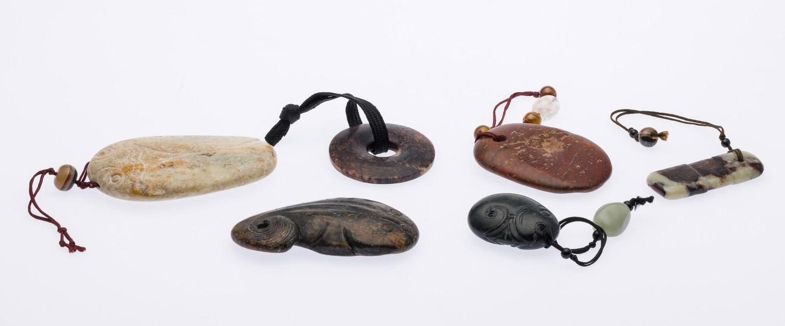 Group of 6 Carved Hardstone Pendants: Property from the Estate of Arthur B. Kouwenhoven Jr., Savannah, GA Description: Group of 6 Carved Hardstone Pendants, comprising a white stone beetle-form pendant on red cord with stone bead, a d