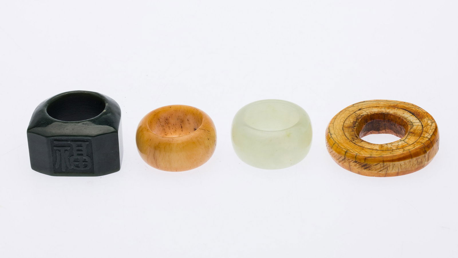 Two Carved Jade and Two Bone Rings (1 of 4)