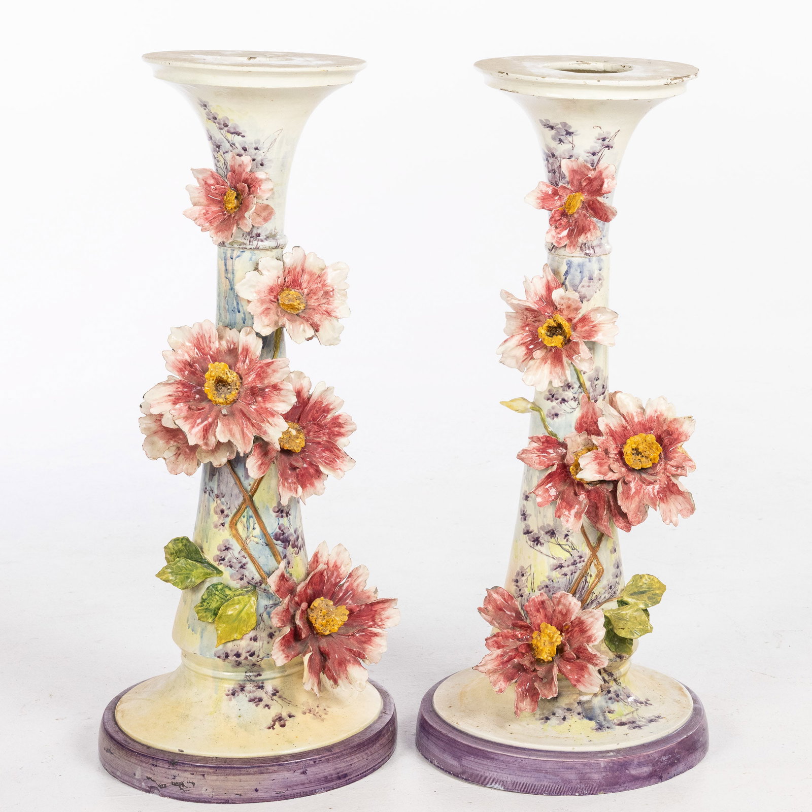 Pair Art Nouveau Italian Ceramic Pedestals, c. 1920: Description: Pair of Art Nouveau Italian Ceramic Pedestals, c. 1920, each with circular top above a flaring standard decorated with pink, yellow and white flowers on a circular base, marked on the