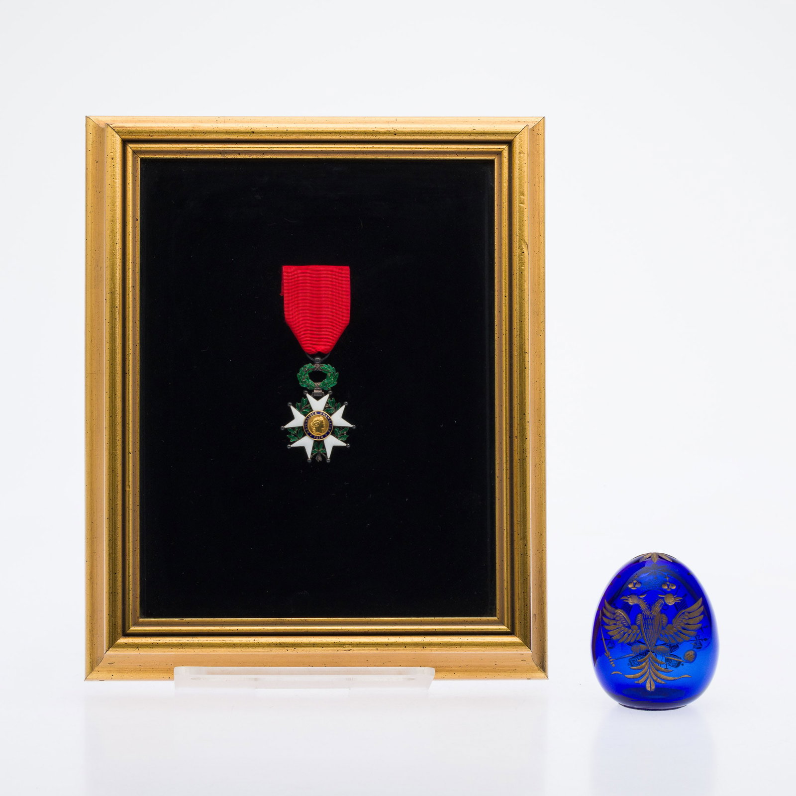 Legion of Honor Medal & Faberge Style Glass Egg: Property from a St. Simons Island, GA EstateDescription: Framed French Legion of Honor Medal and Faberge Style Glass Egg, a French Legion of Honor medal in a giltwood shadow box frame together with a