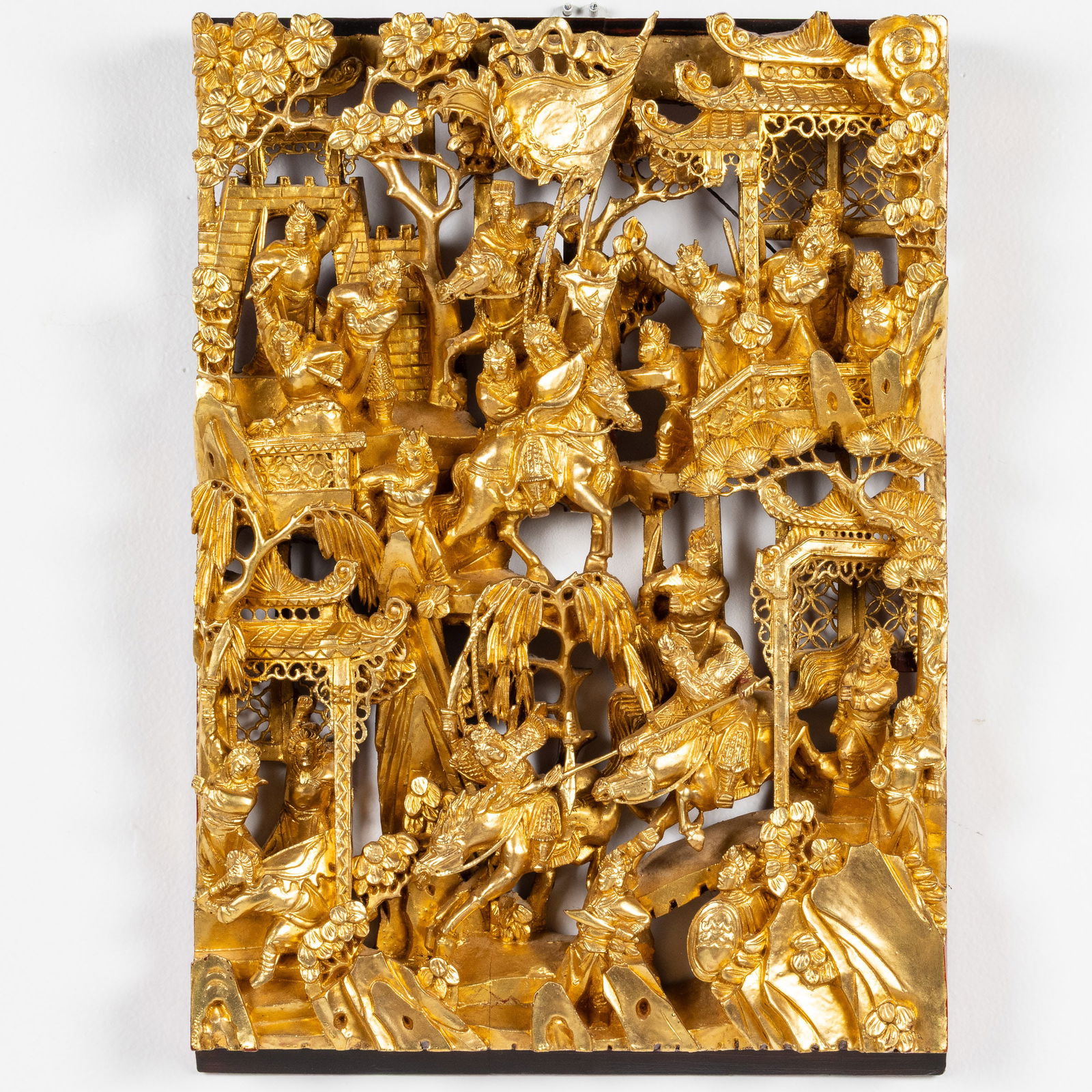 Chinese Carved Giltwood Wall Plaque: Property from a Savannah, GA Estate Description: Chinese Carved Giltwood Wall Plaque, carved with pagodas and warring figures on horseback. Measurements: Height: 16 1/2 in. x Wi