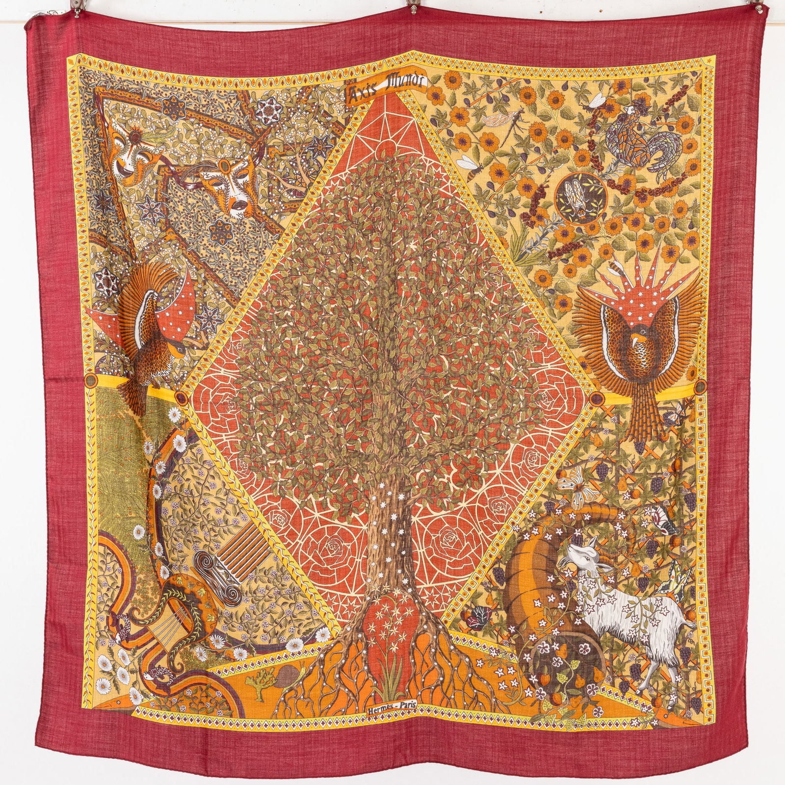 Hermes Axis Mundi Cashmere Shawl: Property from a Private Collection, St. Simons Island, GADescription: Hermes Axis Mundi Cashmere Shawl, signed by Henry C., depicting a central tree, birds, masks, a goat, with red