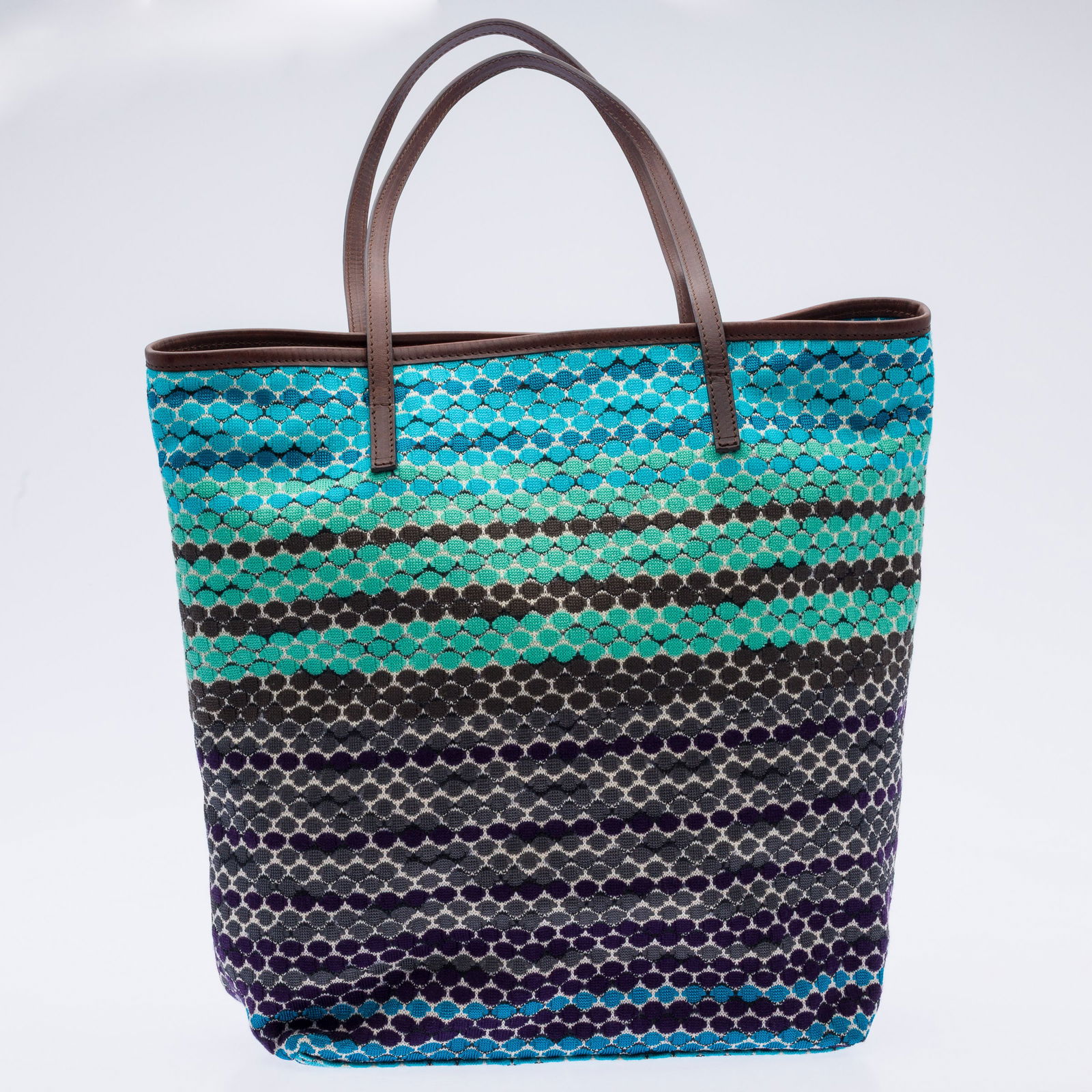 Missoni Intersia Knit Dot Stripe Summer Tote: Property from a Private Collection, St. Simons Island, GADescription: Missoni Intersia Knit Dot Stripe Summer Tote, blue and green polka-dot knit bag with brown leather hem and straps, the top with