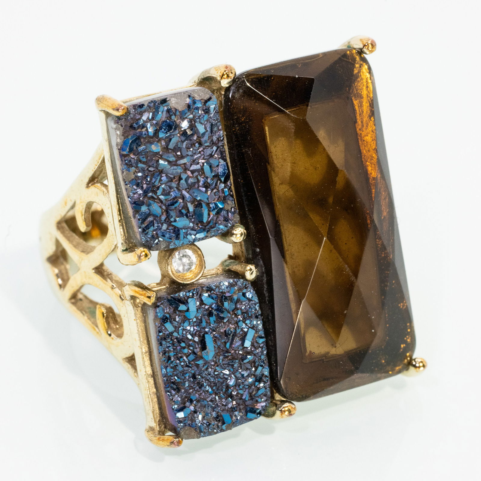 Brown Quartz and Gold Ring: Description: Brown Quartz and Gold Ring, rectangular criss cut brown quartz accented by two dark blue crystalized gemstones, on pierced gold band, with 'Andara' logo, gold unmarked tests 10K. 13.2