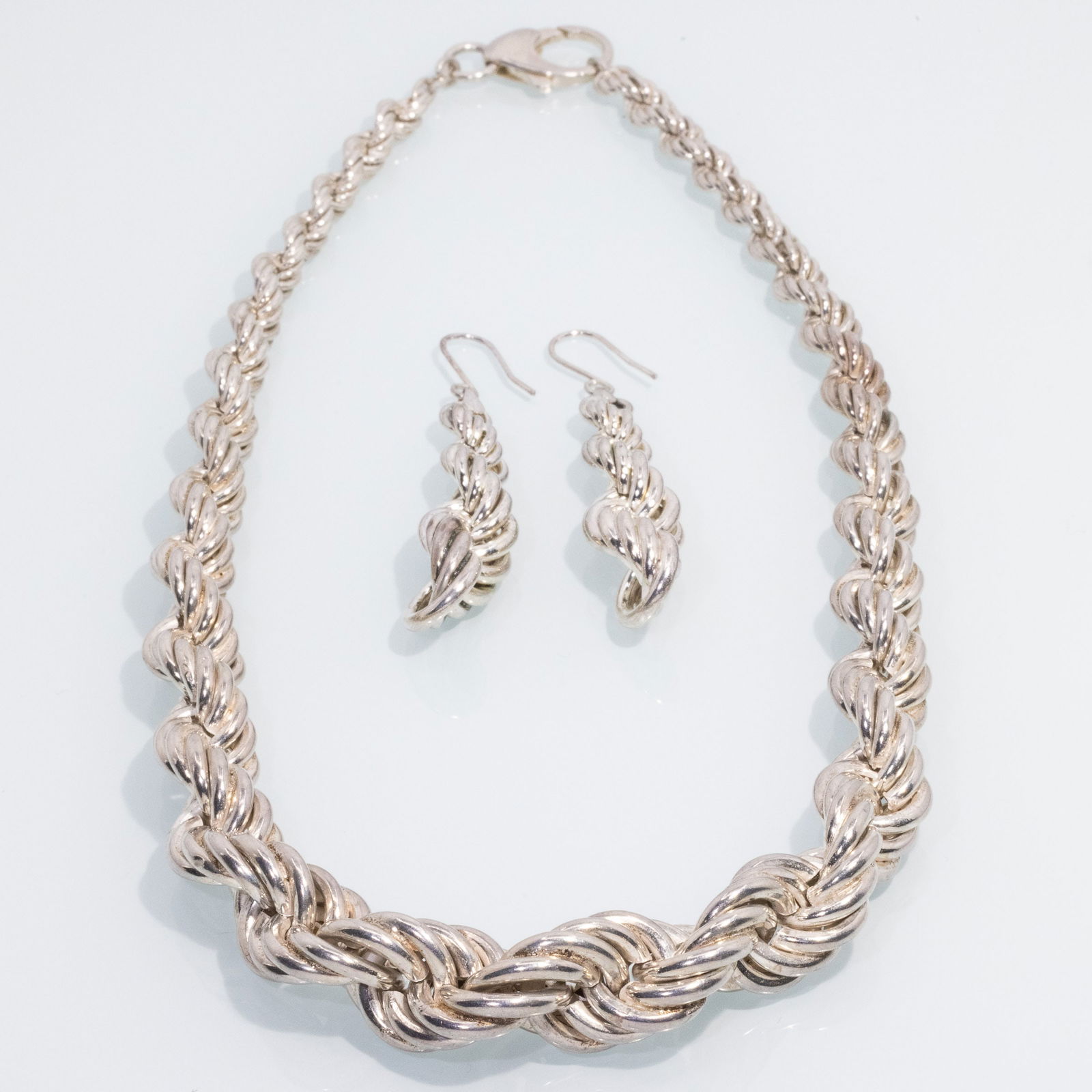 Sterling Twisted Necklace and Matching Earrings: Property from a Savannah, GA EstateDescription: Sterling Silver Twisted Necklace and Matching Earrings, a 19 in. double twist graduated sterling silver chain necklace, claw clasp marked '925', and a