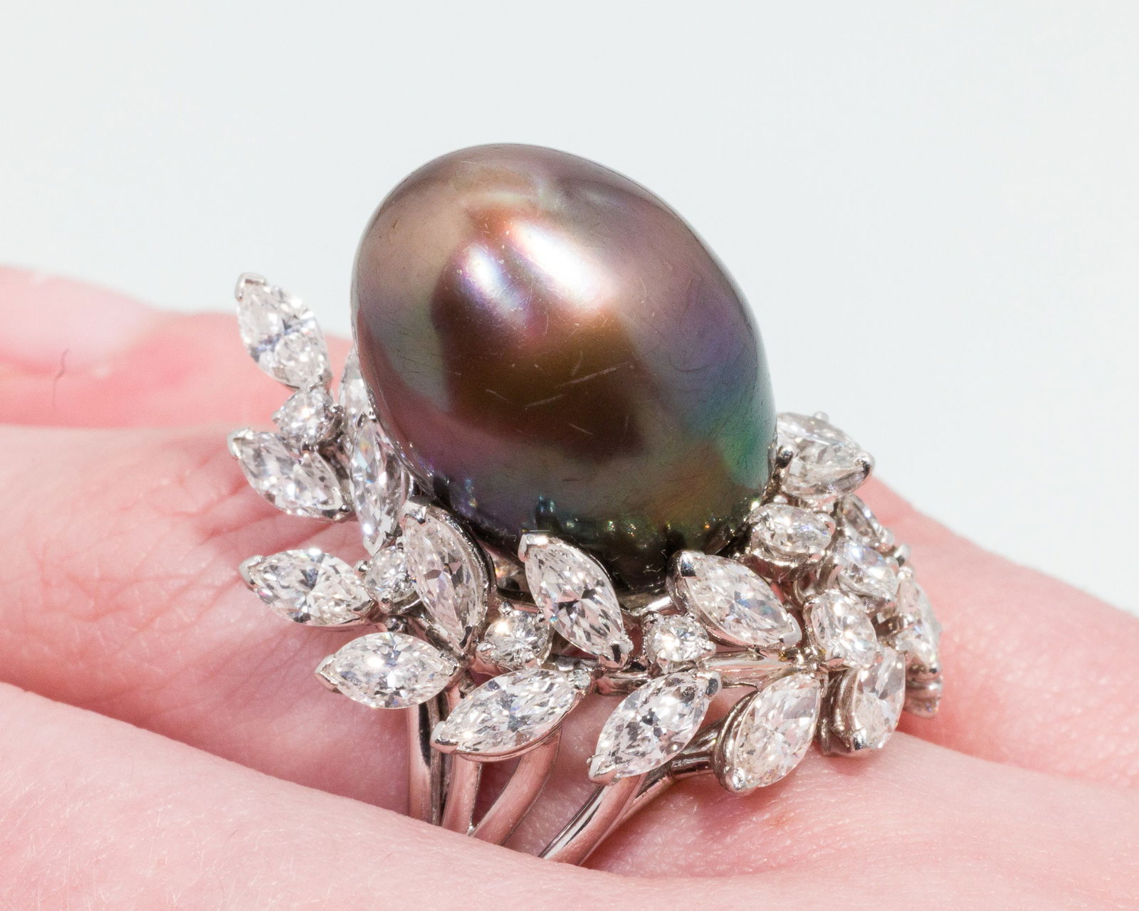 South Sea Peacock Pearl and Diamond 18K Gold Ring: Description: South Sea Peacock Pearl and Diamond 18K Gold Ring, 18K white gold ring featuring a South Sea peacock pearl (approx. 17.9 mm x 13.8 mm) surrounded by various round and lozenge cut dia