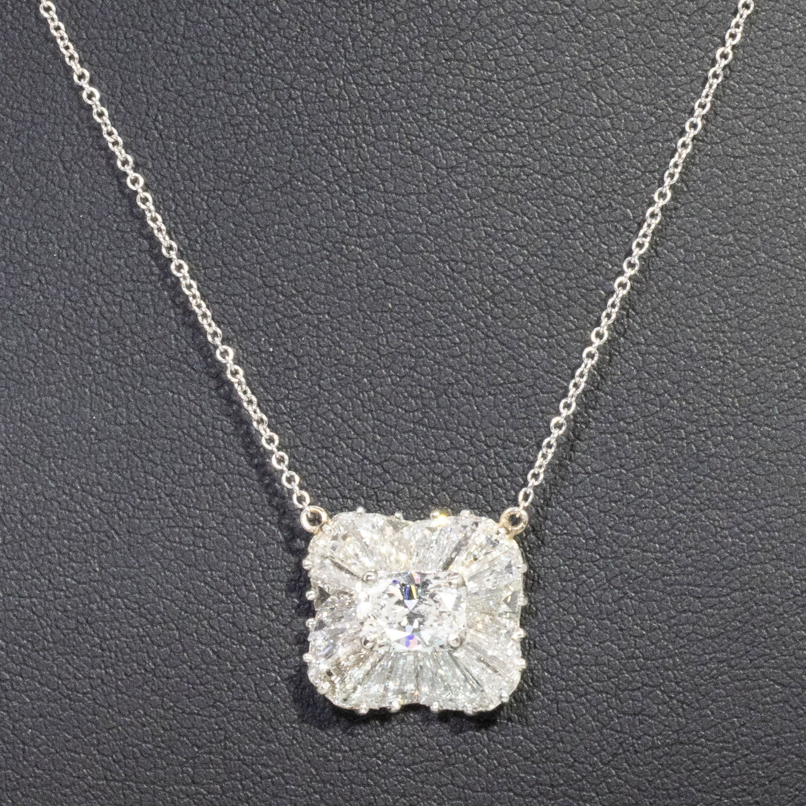 Diamond and 14K Gold Necklace: Description: Diamond and 14K Gold Necklace, featuring an approx. 2 1/4 ct diamond center stone measuring approx. 7 mm x 5 mm x 2.8 mm surrounded by contouring baguette, with 14K white gold mounting