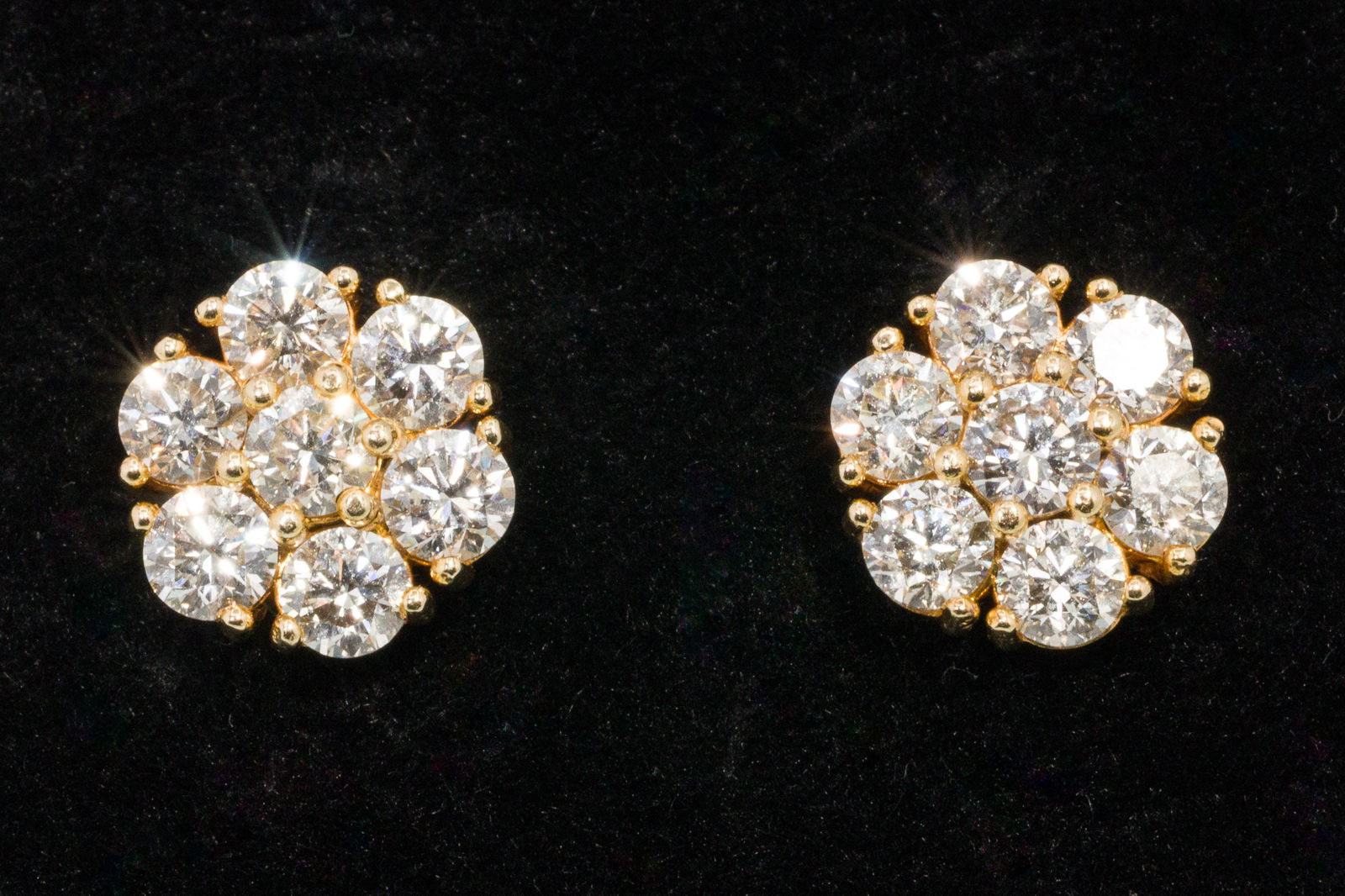 Diamond and 18K Cluster Earrings: Description: Diamond and 18K Cluster Earrings, 18K yellow gold stud earrings each with featuring a cluster of seven prong set round brilliant diamonds (approx. 2.2 cts, H-VS), with twist back,