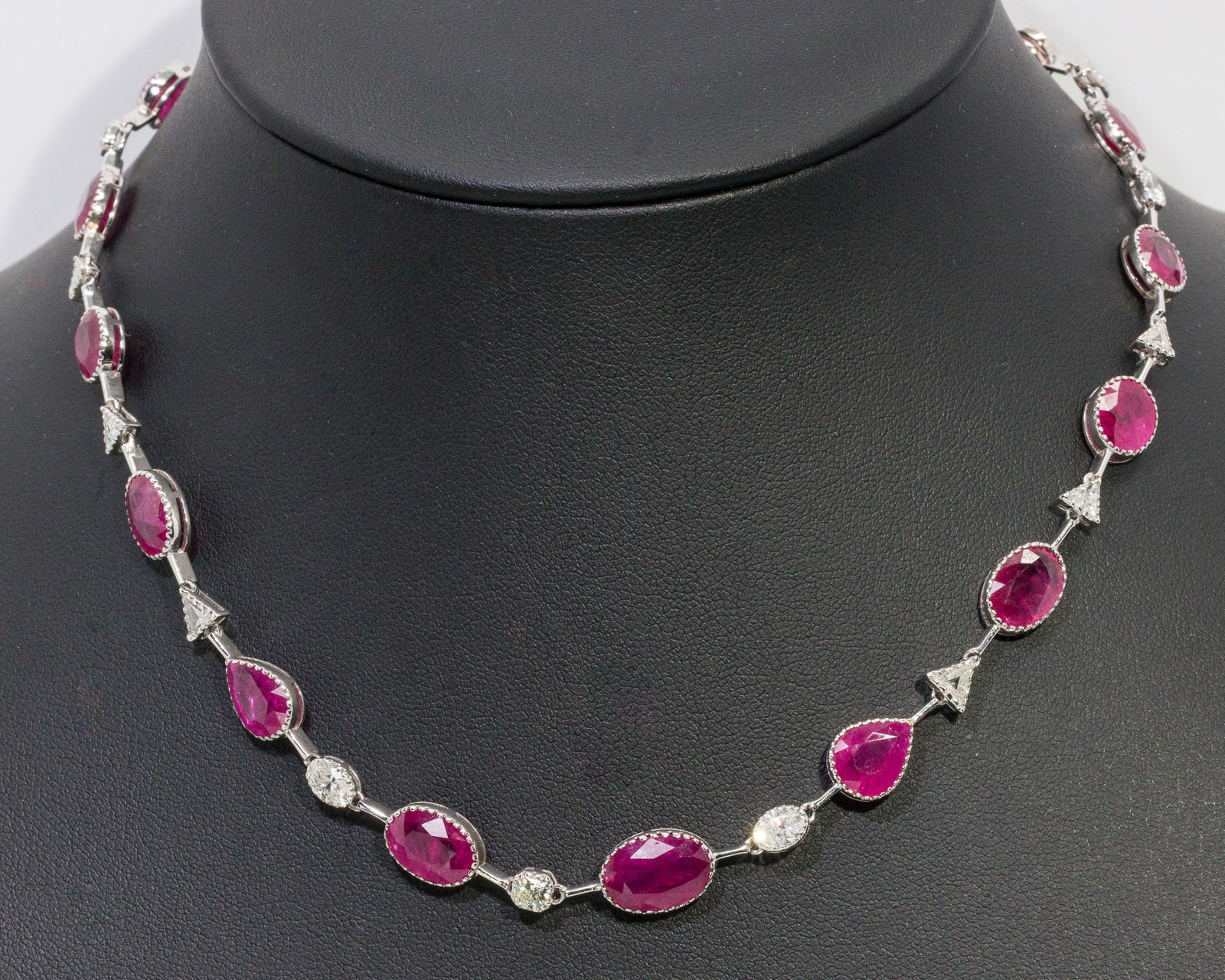 14K Gold, Natural Ruby and Diamond Necklace: Description: 14K Gold, Natural Ruby and Diamond Necklace, 14K white gold necklace featuring round, oval and pear cut natural rubies (approx. 37.07 cts) and triangular and oval cut diamonds (approx.