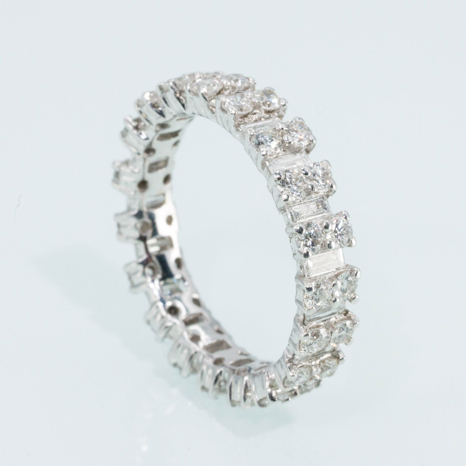 Diamond and 18K Gold Infinity Band: Description: Diamond and 18K Gold Infinity Band, 18K white gold band set with alternating round and baguette diamonds (approx. 2 cts total, F-G, VS), marked '18K' with illegibly makers mark on