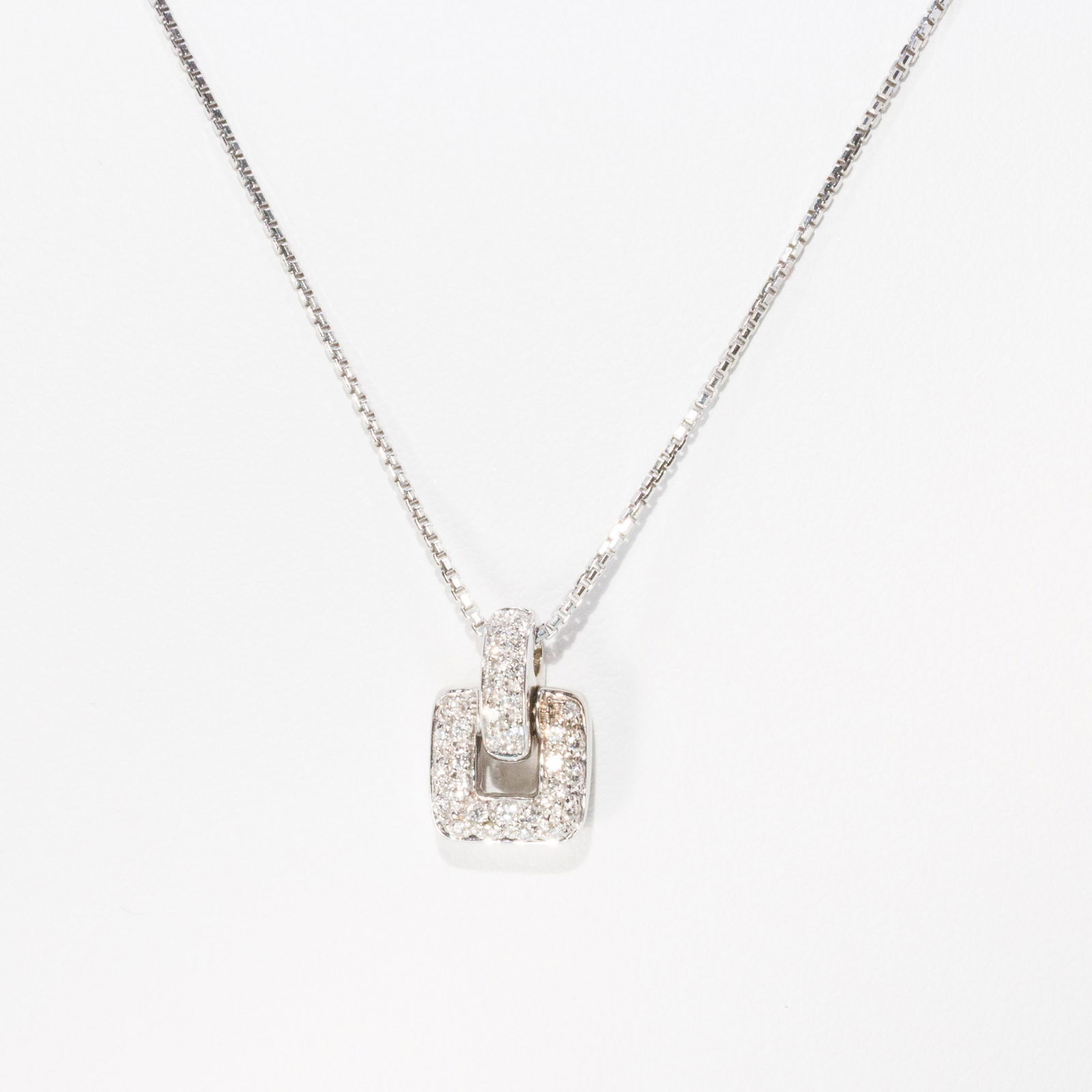 18K Gold and Diamond Pendant Necklace: Description: 18K Gold and Diamond Pendant Necklace, 18K white gold and pave set diamond square link pendant on a 18K white gold chain, marked 'Damiani, 3181Al, 750' near lobster claw clasp. 6.91