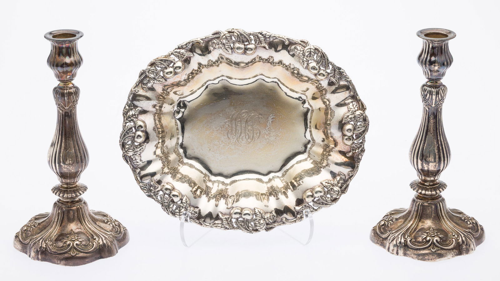 Pair Gorham Sterling Candlesticks and Sterling Bowl: Property from a Private Collection, Savannah, GADescription: Pair of Gorham Sterling Candlesticks and a Sterling Repousse Bowl, the candlesticks weighted and decorated with flowers and C-scrolls. 