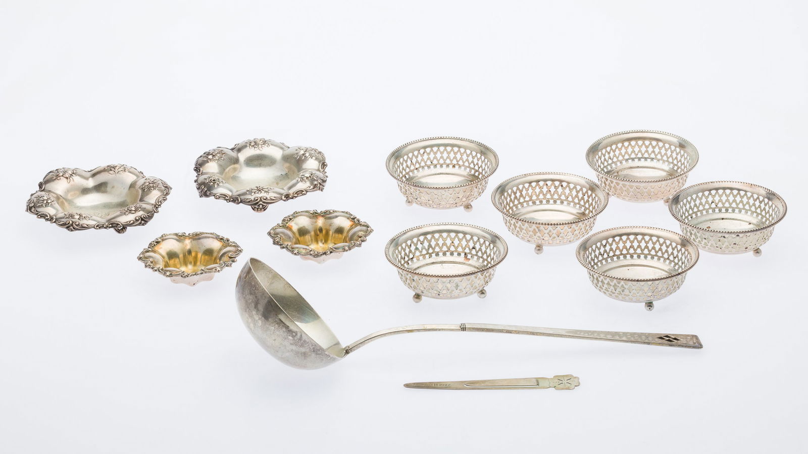 10 Sterling Bon-Bons, a Ladle and Tiffany Bookmark: Property from a Private Collection, Savannah, GADescription: 10 Sterling Bon-Bons, a Ladle and Tiffany Bookmark, comprising 2 Gorham monogrammed floral repousse bon bons, 6 Gorham pierced bon bons