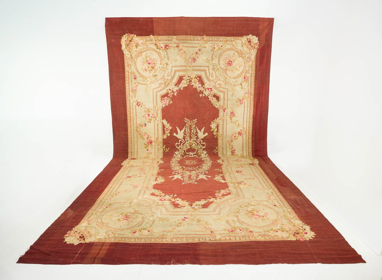 French Aubusson Carpet, 19th Century: Property from a Private Collection, New York City Description: French Aubusson Carpet, 19th Century, the central roundel with monogram and doves, surrounded by a floral border on a mauve ground. P