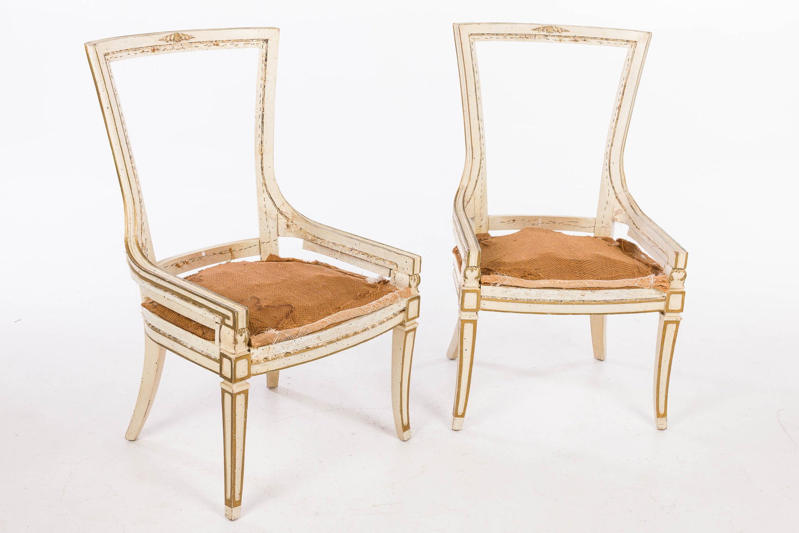 Pair of Neoclassical Style White Painted Side Chairs: Property from a Private Collector, Savannah, GA Description: Pair of Neoclassical Style White Painted Side Chairs, each with tapering backs raised on slightly outflared legs with gold highlights.<