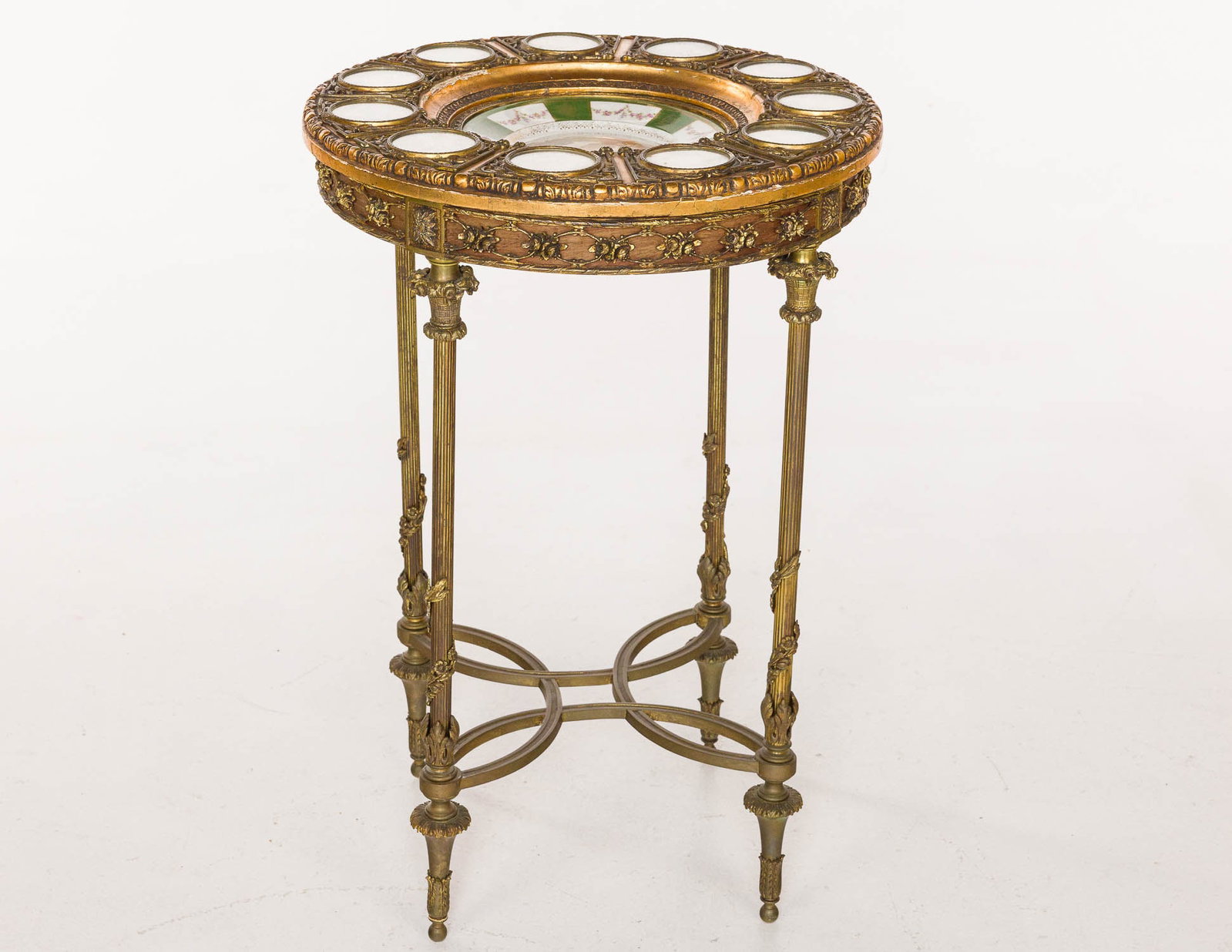 Louis XVI Style Gilt Metal & Porcelain Side Table: Property from a Private Collection, New York City Description: Louis XVI Style Gilt Metal and Porcelain Circular Side Table, mounted with a German porcelain charger painted with a woman surrounded by
