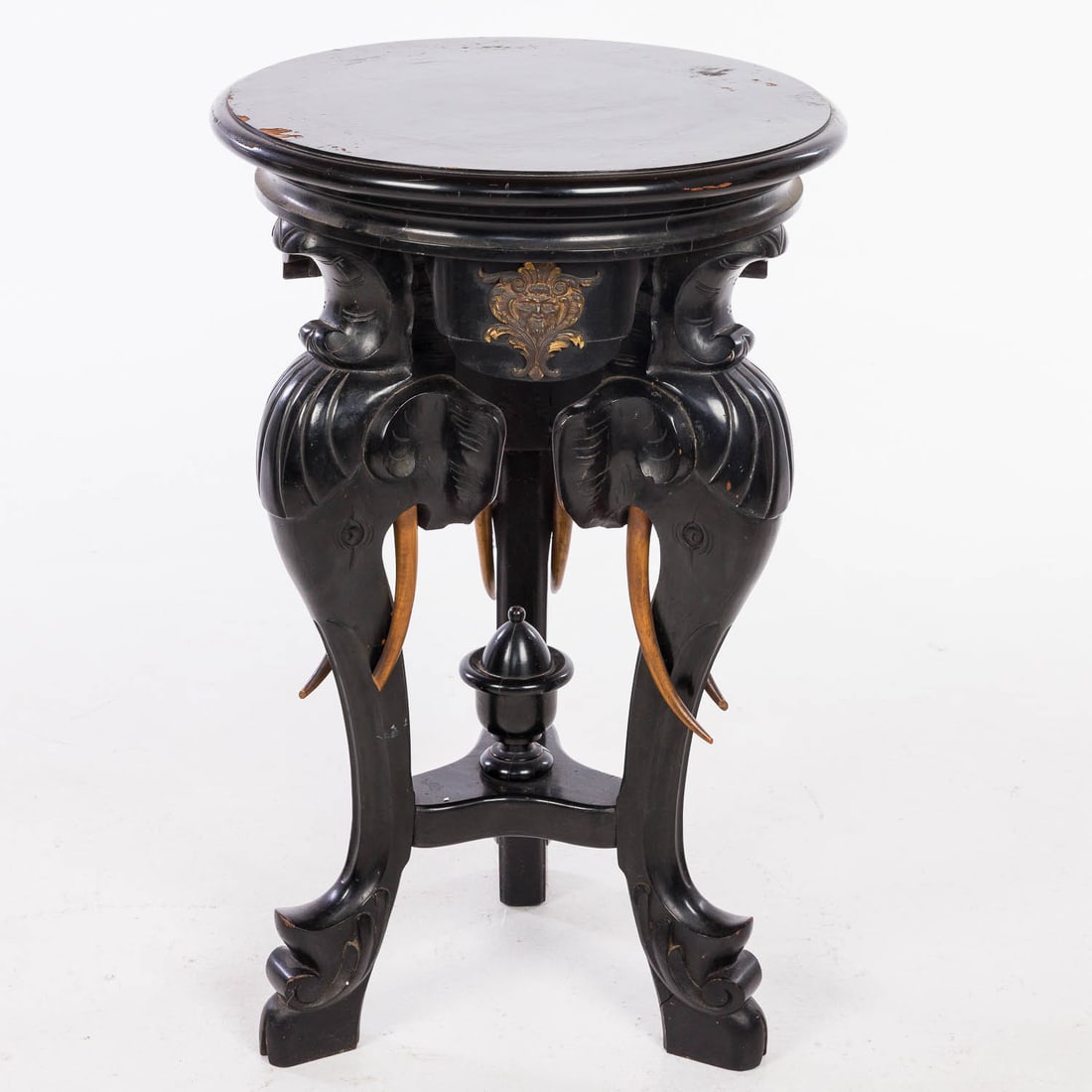 Elephant Black Painted Pedestal Table: Property of a Private Collector, Savannah, GA Description: Elephant Black Painted Pedestal Table, with circular rotating top, raised on three legs carved with elephant heads. Measurements: Height: 33