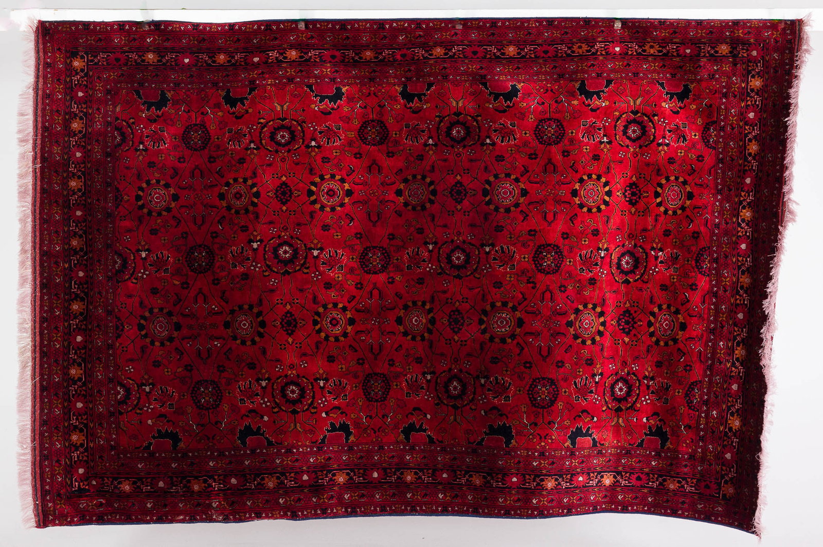 Persian Rug: Description: Persian Rug, in tones of red and black with geometric pattern and floral border. Measurements: Length: 9 ft. 7 in. x Width: 78 in.