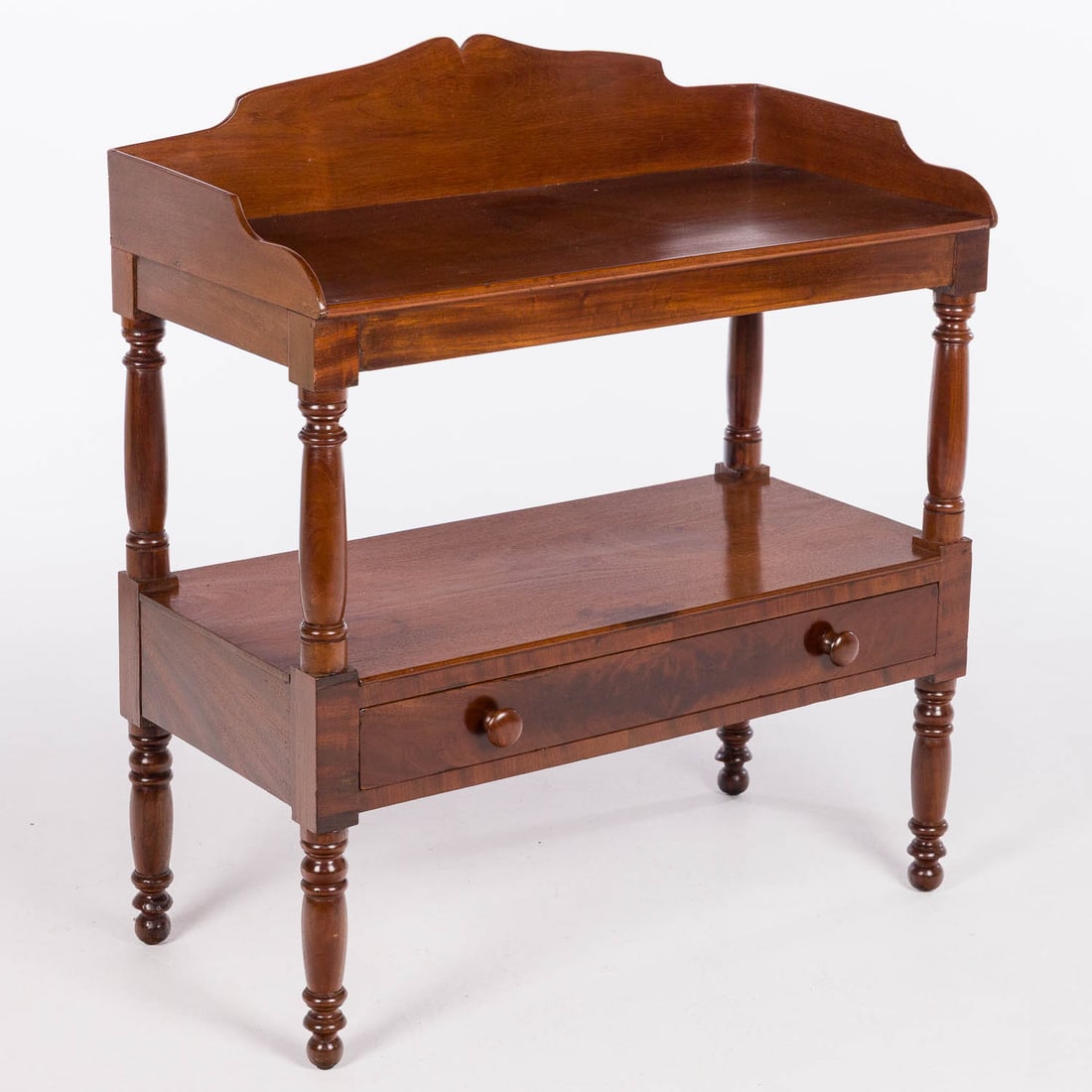 American Mahogany Washstand, 19th Century: Property of a Private Collector, Savannah, GA Description: American Mahogany Washstand, 19th Century, the rectangular top with three quarter shaped gallery above a central shelf with drawer, raised