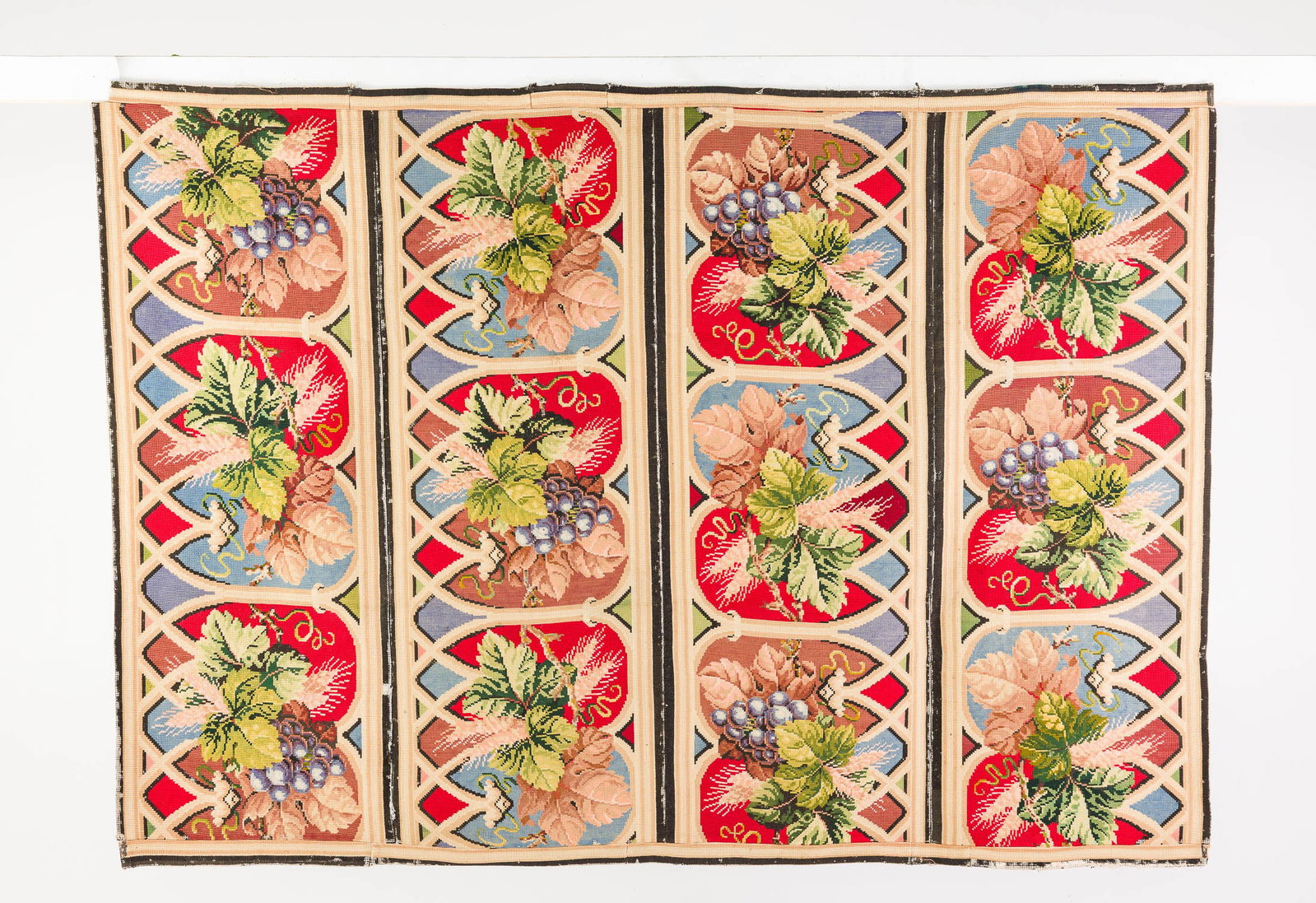 English Needlepoint Rug with Grapes, 19th C: Property from a Private Collection, New York City Description: English Needlepoint Rug with Grapes, 19th C, with four panels decorated with gothic arch design with grapes. Provenance: purchased at