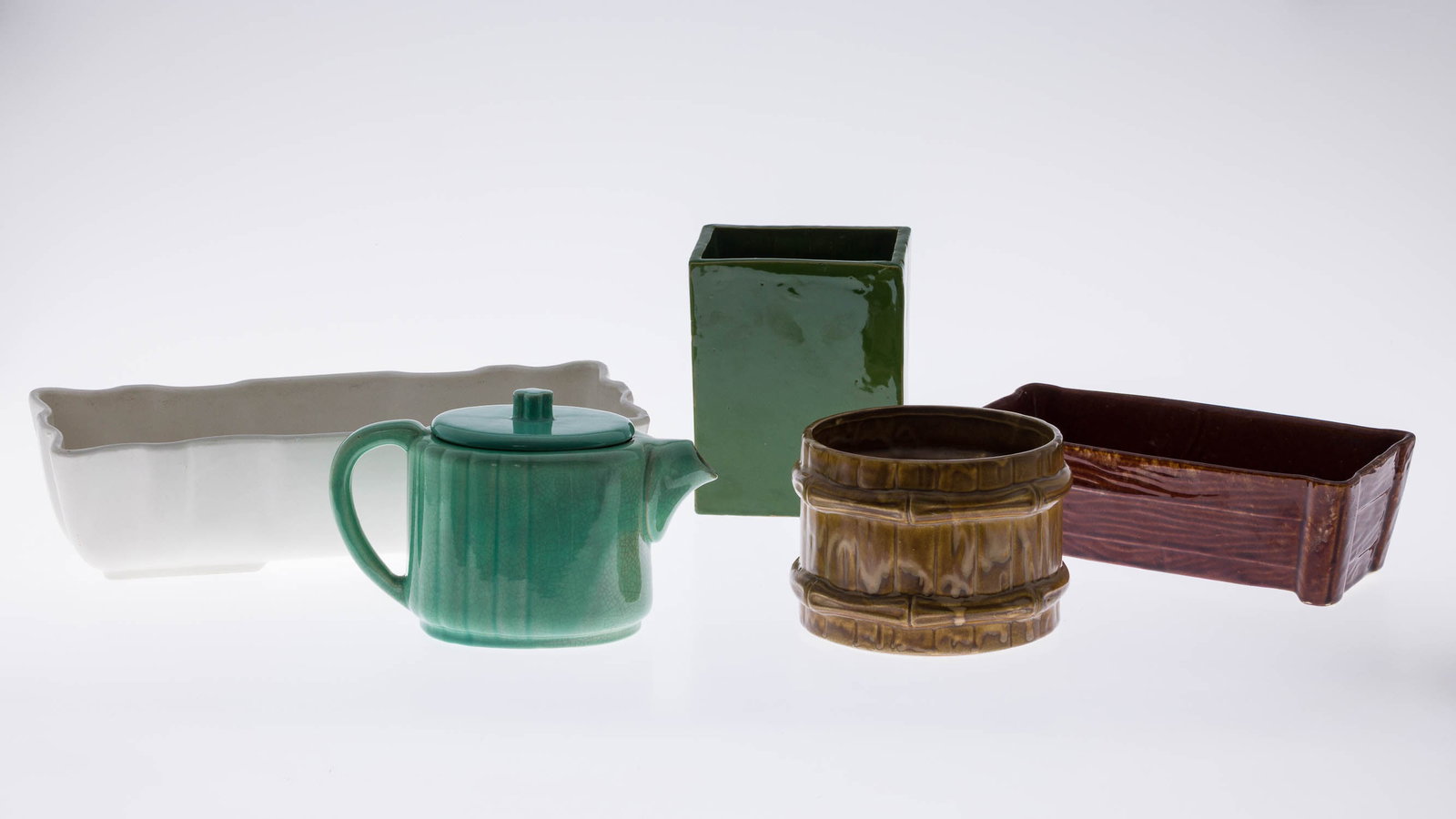 4 Ceramic Planters and a Ceramic Teapot: Description: 4 Ceramic Planters and a Ceramic Teapot, comprising a green square sided vase (marked 'Italy' on bottom), a McCoy bucket-form planter (with impressed mark '209 McCoy USA' on bottom), a