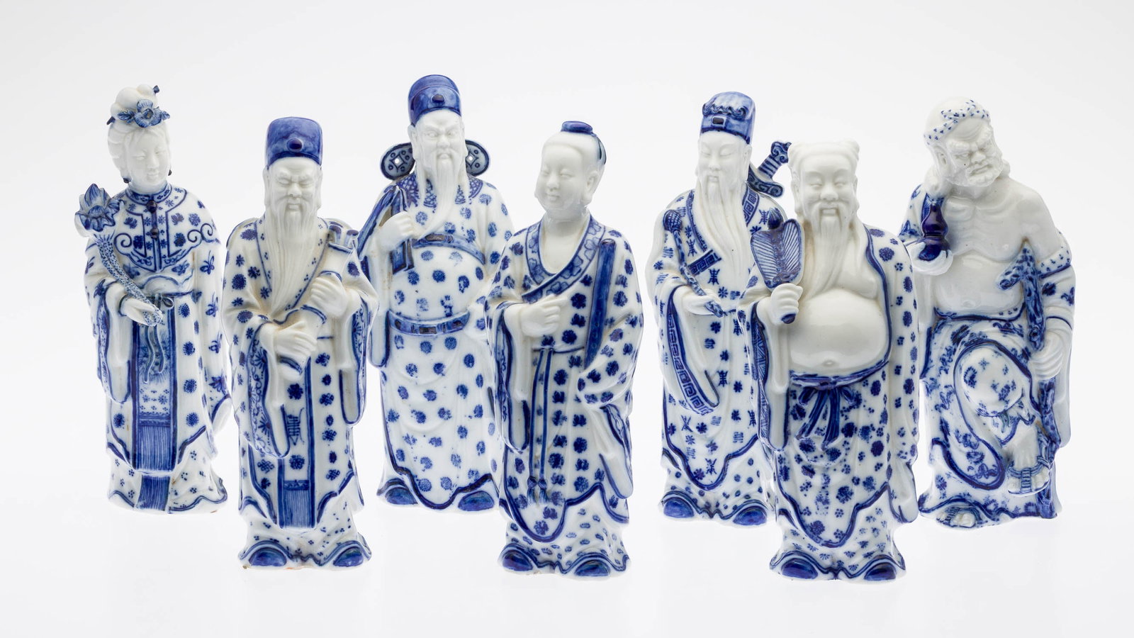 Group of 7 Chinese Blue-and-White Porcelain Figures: Description: Group of Seven Chinese Blue-and-White Porcelain Figures, each figure in blue and white holding an object in one hand, some with identification labels on verso. Measurements