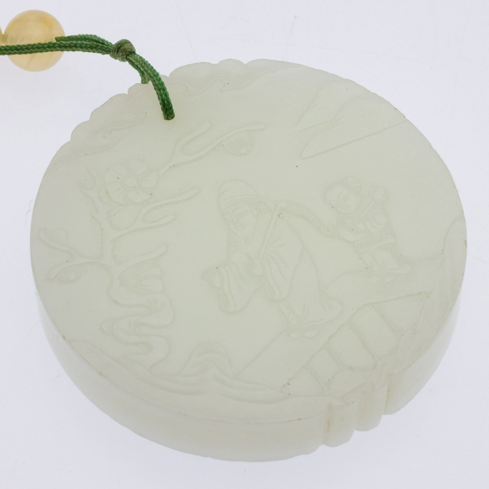 Chinese Carved White Jade Circular Pendant: Property from the Estate of Arthur B. Kouwenhoven Jr., Savannah, GA Description: Chinese Carved White Jade Circular Pendant in Fitted Box, one side carved with two figures and a flowering branch, the