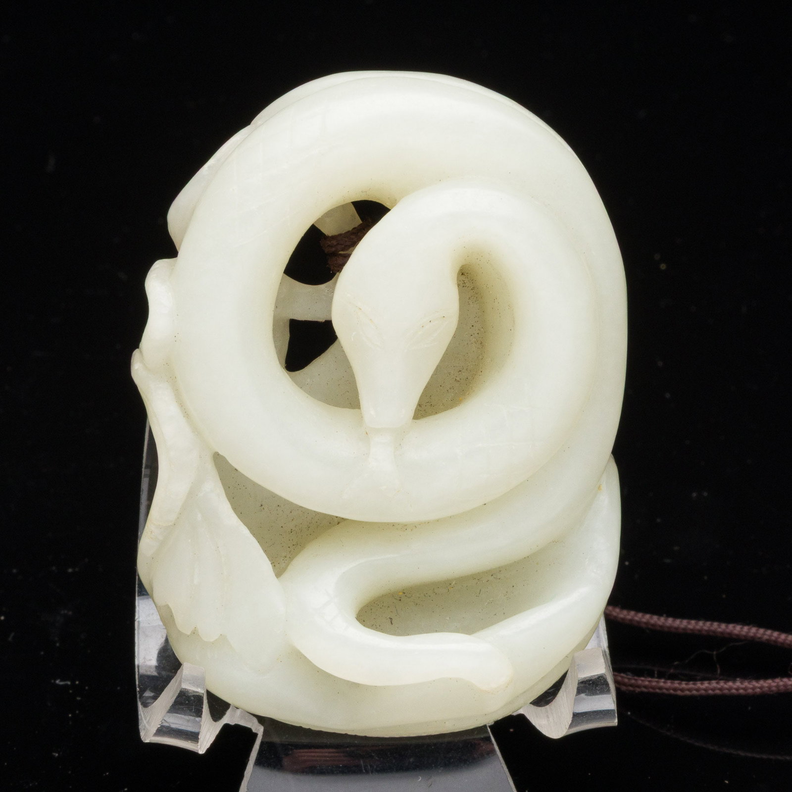 Chinese Carved White Jade Snake Pendant: Property from the Estate of Arthur B. Kouwenhoven Jr., Savannah, GA Description: Chinese Carved White Jade Snake Pendant, carved as a coiled snake with fruit on verso. Measurements: Height: 2 1/2 in.