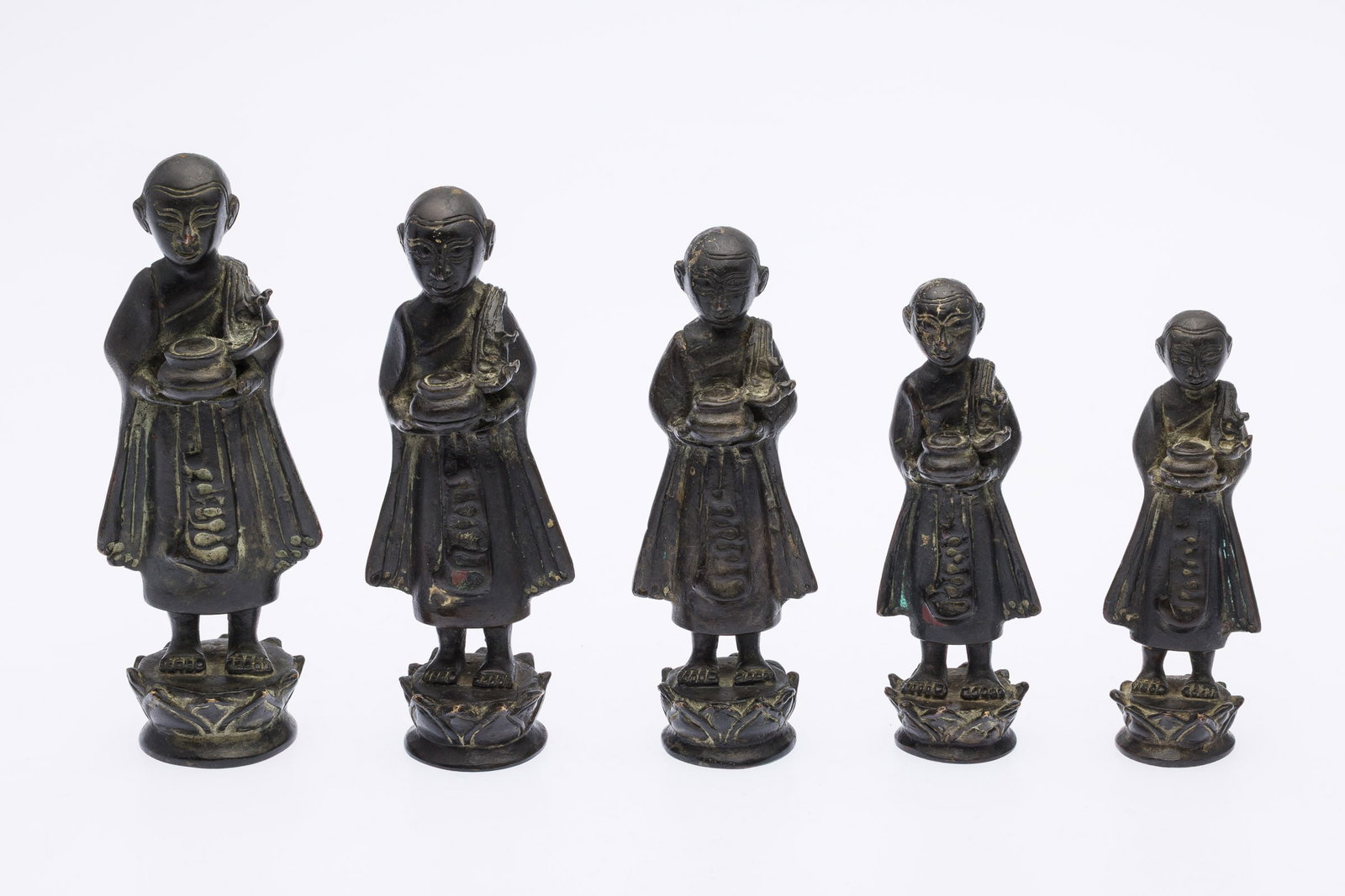 5 SouthEast Asian Monk Opium Weights: Property from the Estate of Arthur B. Kouwenhoven Jr., Savannah, GA Description: 5 SouthEast Asian Monk Opium Weights, five graduated monk figures on lotus blossom bases. Measurements: <
