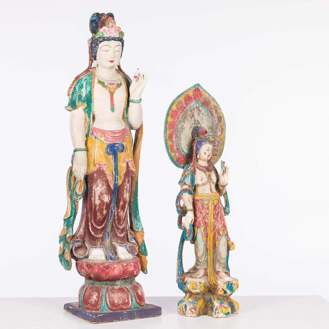 Two Southeast Asian Painted and Carved Wood Guanyin: Property of a Private Collector, St. Helena Island, SC Description: Two Southeast Asian Painted and Carved Wood Guanyin, the smaller one with lotus halo (24 3/4 in. x 7 in. x 5 in.), the larger one