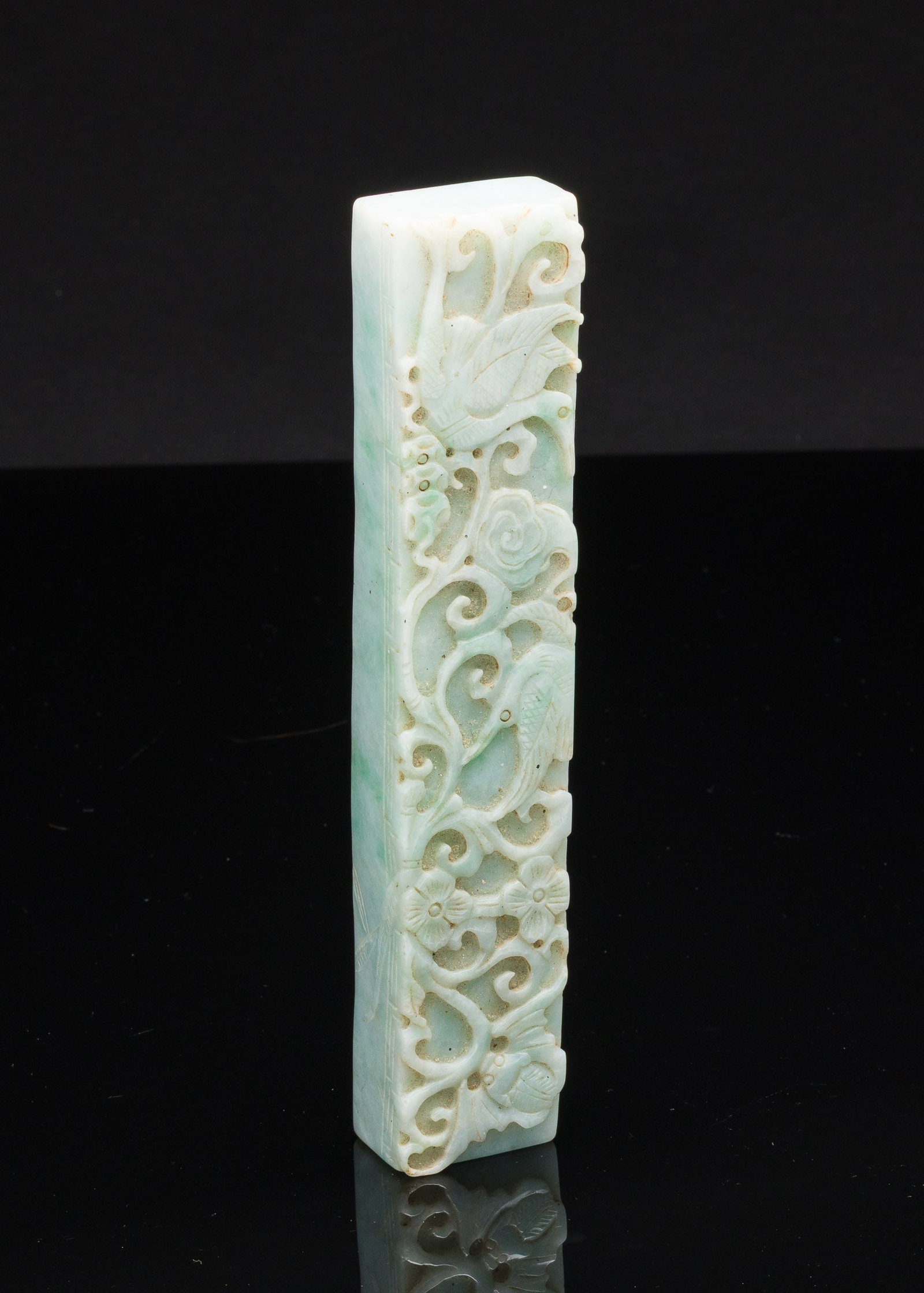 Chinese Jadeite Scroll Weight: Property from the Estate of Arthur B. Kouwenhoven Jr., Savannah, GA Description: Chinese Jadeite Scroll Weight, carved with flowers, birds, and bats. Measurements: Height: 7 7/8 in. x Width: 1 1/2