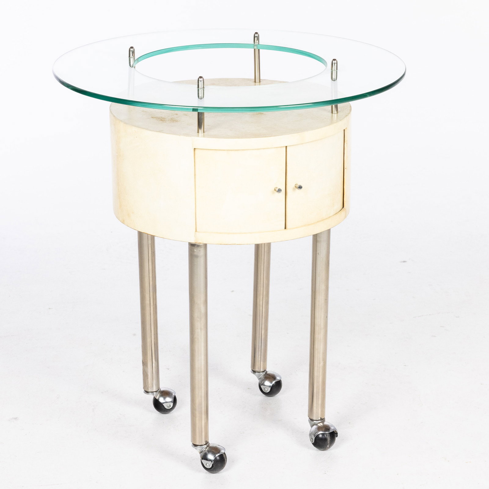 R & Y Augousti Shagreen and Chrome Bar: Description: R & Y Augousti Shagreen and Chrome Bar, with glass top above sliding doors raised on circular legs on casters. Measurements: Height: 29 in. x Width: 25 1/2 in.