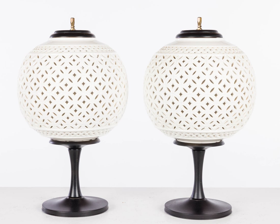 Pair of Ceramic Mid Century Pierced Ball Form Lamps: Property of a Private Collector, St. Helena Island, SC Description: Pair of Ceramic Mid Century Pierced Ball Form Lamps, each with white glazed pierced ceramic globe on a painted wood base, electr