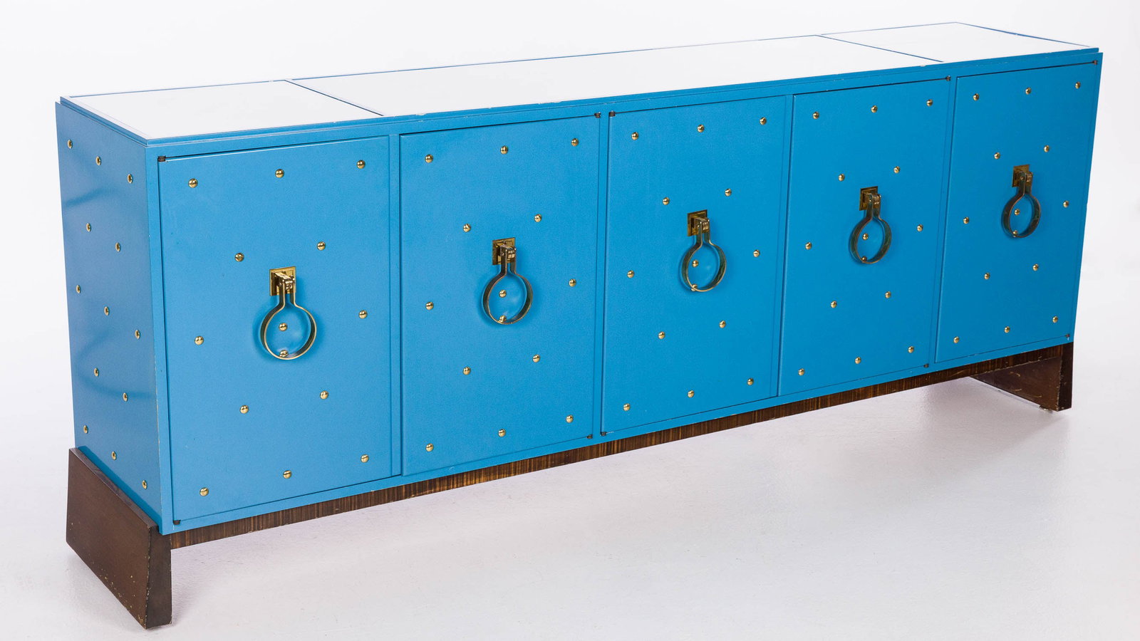 Tommi Parzinger Blue Lacquer Side Cabinet, c. 1950's: Property from a Private Collection, Savannah, GA Description: Tommi Parzinger Blue Lacquer Side Cabinet, c. 1950's, with white glass inset three part top above 5 cabinet doors mounted with metal