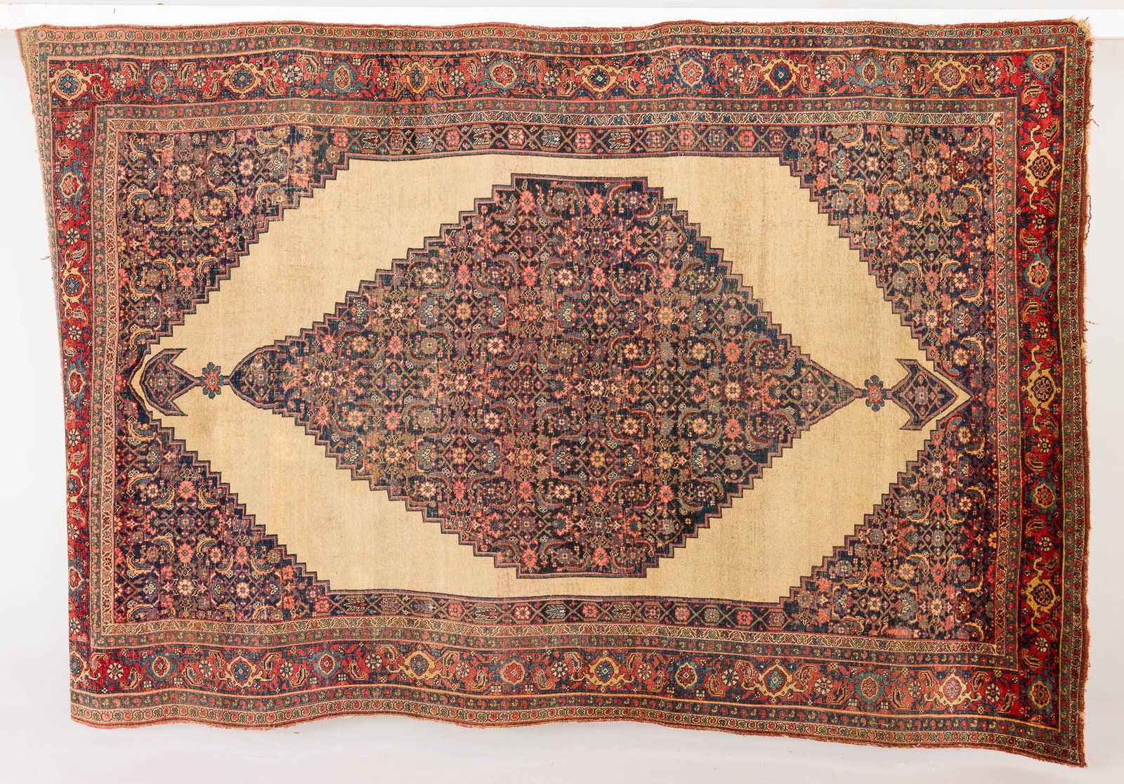 Antique Persian Hall Rug: Property from a Private Collection, Bluffton, SC Description: Antique Persian Hall Rug, in tones of dark blue, cream, pink on a cream ground with green border. Measurements: Len