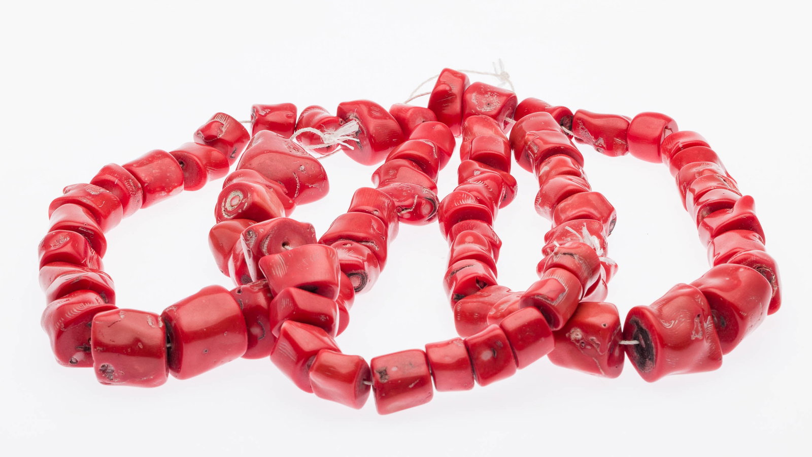 3 Strands of Large Coral Beads: Description: 3 Strands of Large Coral Beads, comprising 76 coral beads in various sizes. Measurements: Width: of largest bead 1 3/4 in.