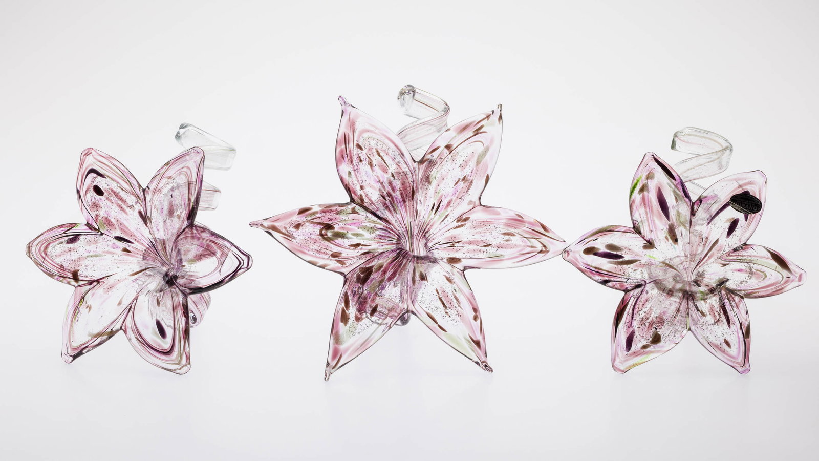 3 Purple Murano Glass Flower Candleholders: Description: 3 Purple Murano Glass Flower Candleholders, each of slightly different size, with spiral candleholder at back, one with 'Vetro Eseguito, Secondo La Tecnica Dei Maestri Di Murano, Made in