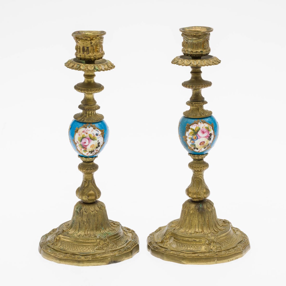 Pair of French Gilt Metal and Porcelain Candlesticks: Description: Pair of French Gilt Metal and Porcelain Candlesticks, gilt metal candlesticks with floral painted porcelain bulbs. Measurements: Height: 9 3/8 in. x Width: 4 1/4 in. x Depth: 4 1/4 in.