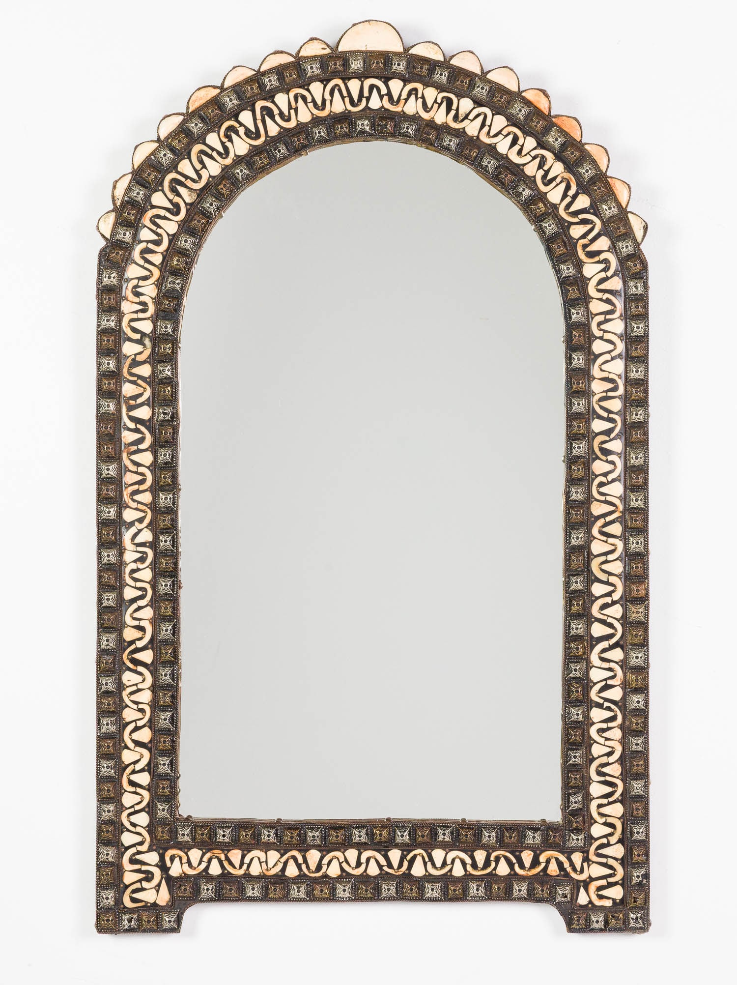 Moroccan Metal and Bone Arched Mirror: Property of a Private Collector, Savannah, GA Description: Moroccan Metal and Bone Arched Mirror. Measurements: Height: 40 in. x Width: 24 in.